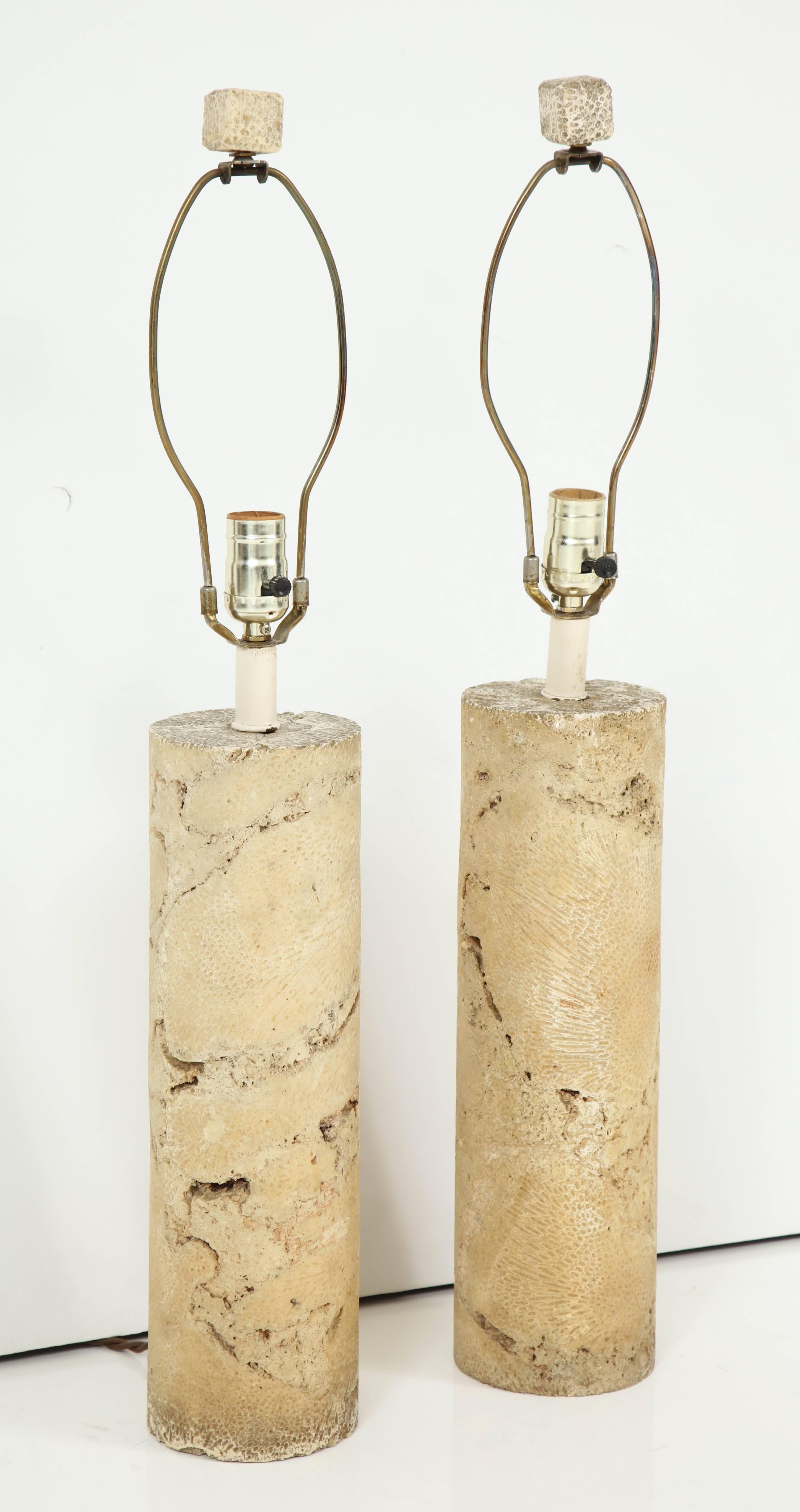 Elegant pair of solid fossil coral lamps, USA, 1960s, rewired and retain their solid coral finials. Custom shades available. Price is for the pair.