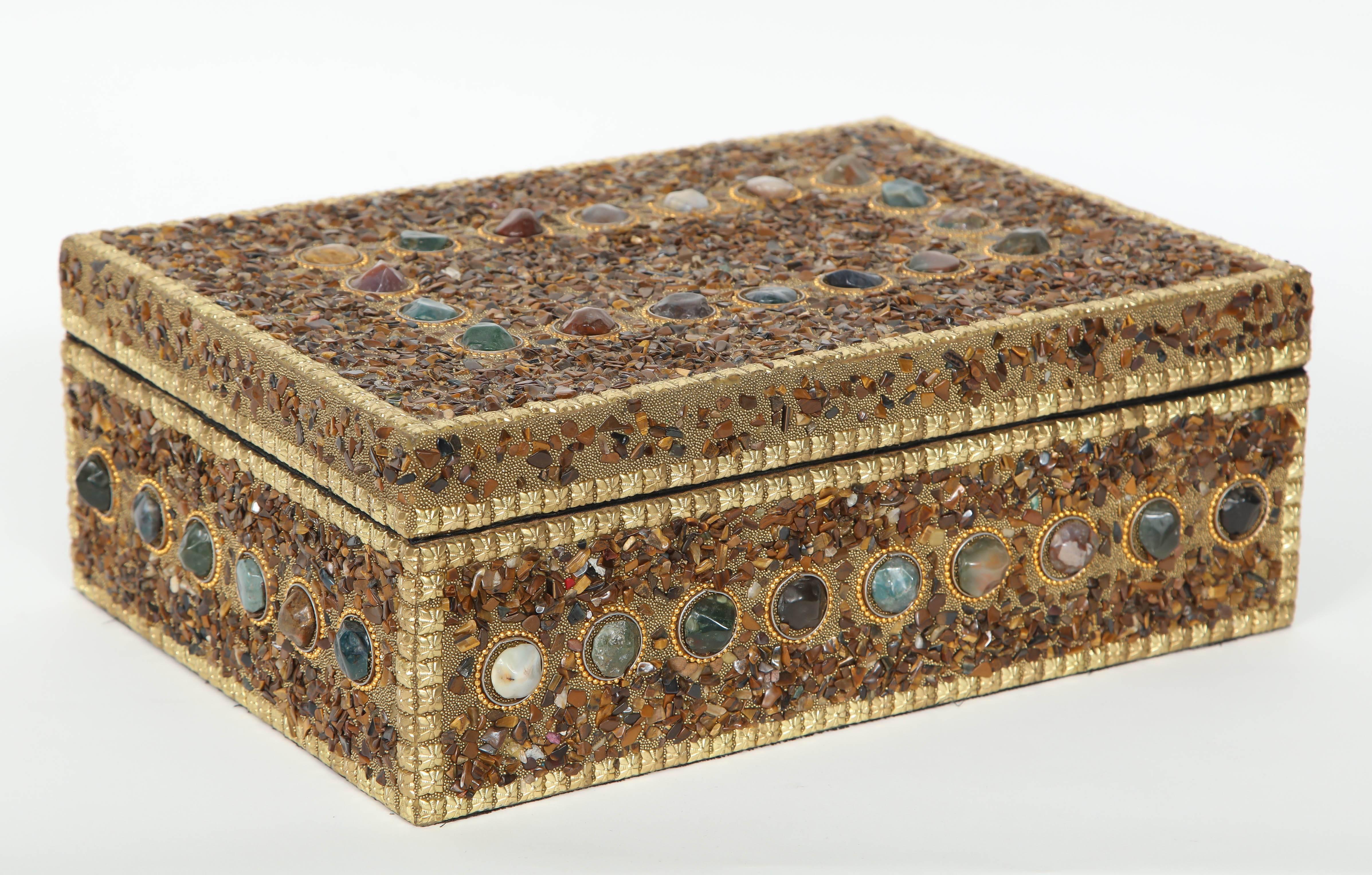 Large keepsake box decorated in its entirety in tiger's eye and trimmed with decorative brass squares and circular Jade pieces. Interior lined in black velvet.