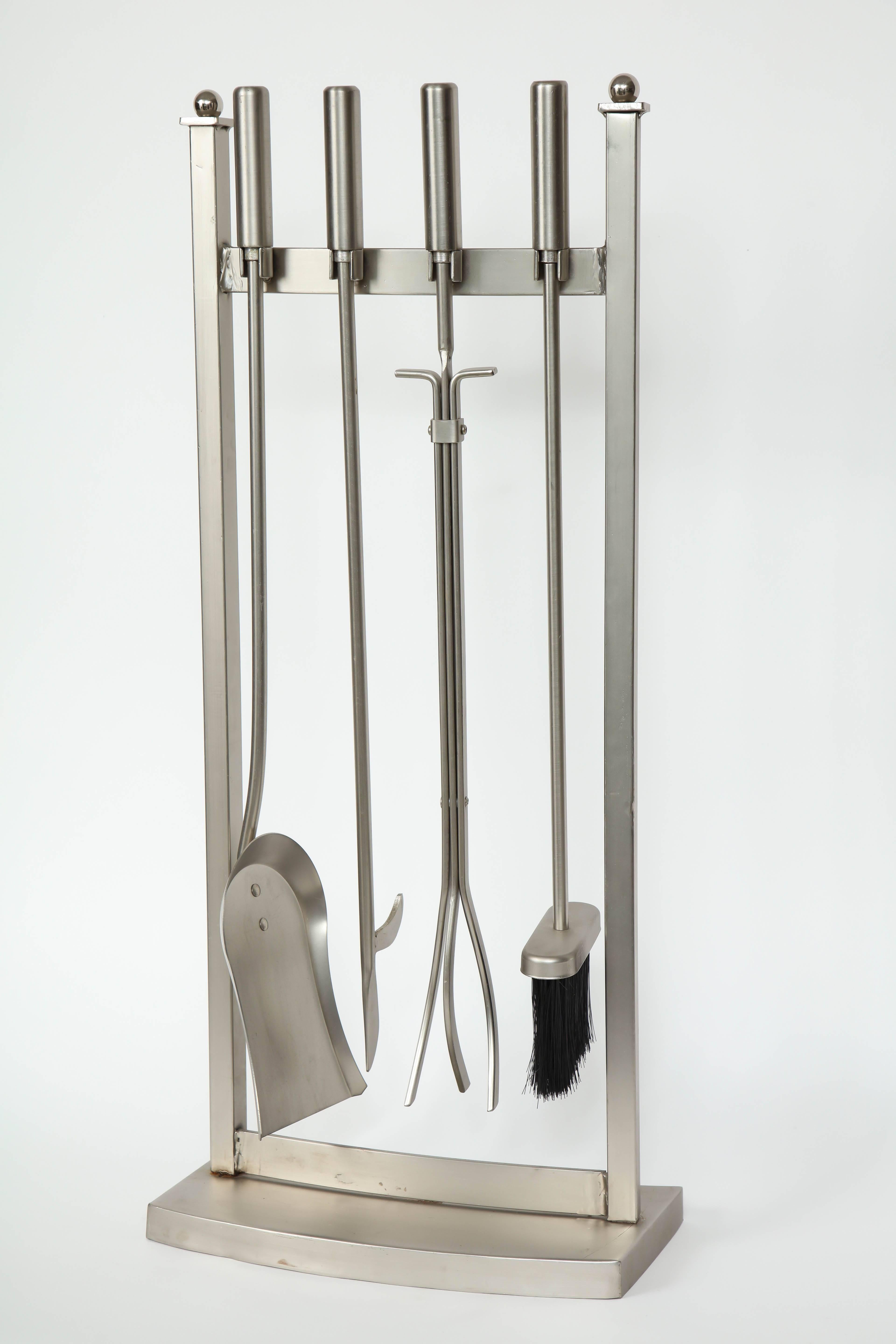 Modernist five-piece set of fireplace tools in brushed steel. Set includes stand, poker, shovel, tongs and broom.