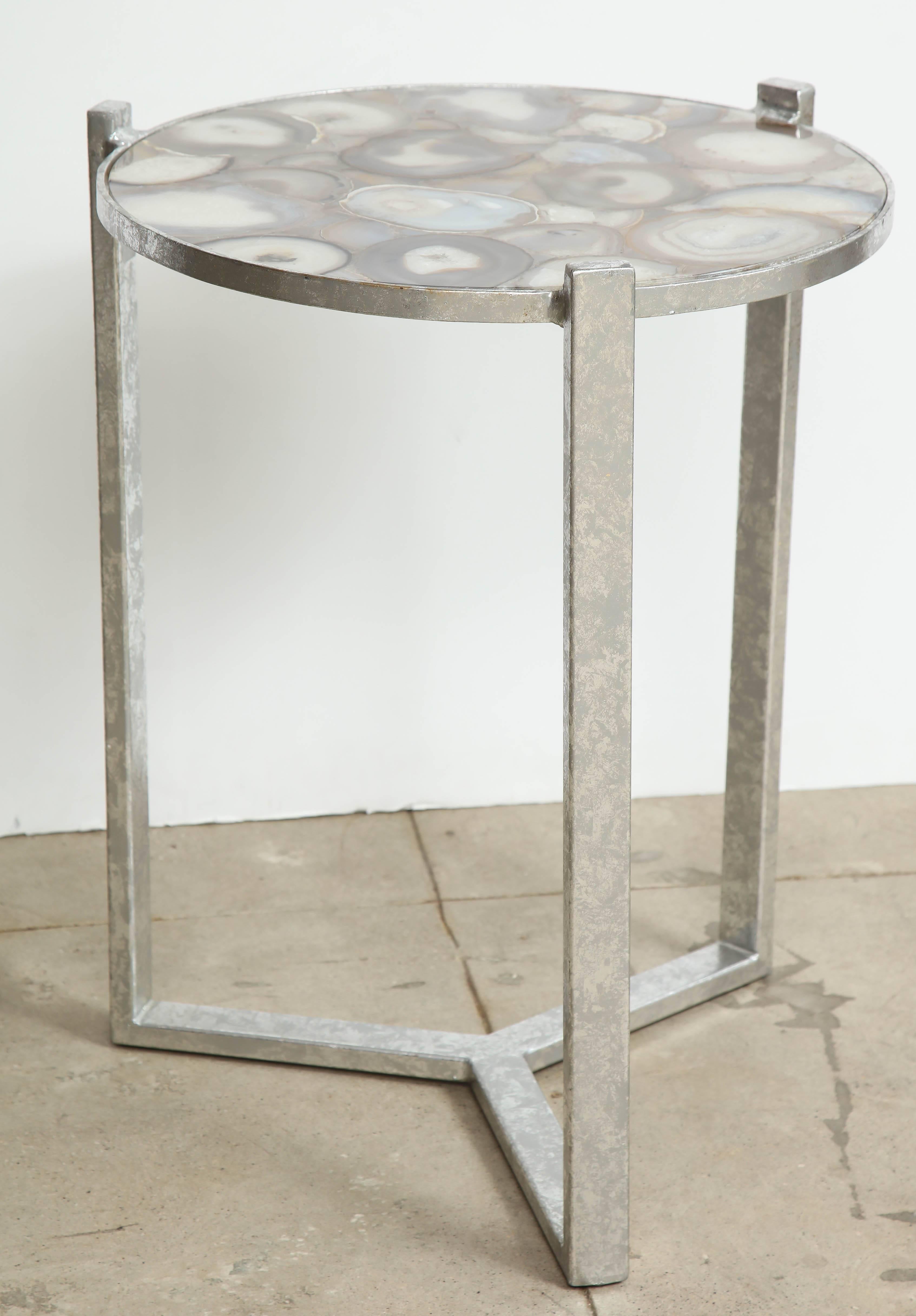 Contemporary silvered iron side table with sliced agate geode slices in colors of taupe, cream and browns suspended in clear resin. 