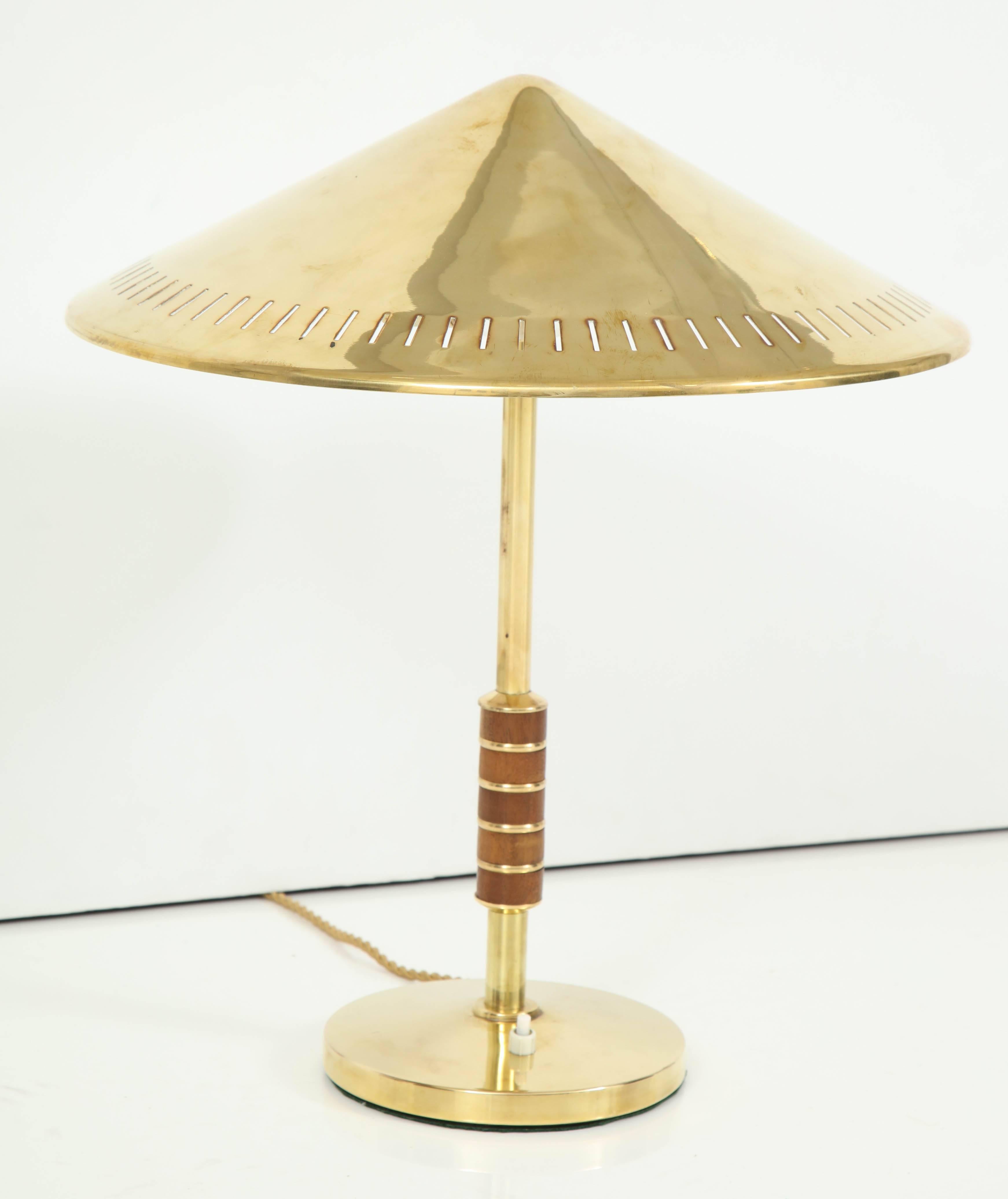 A Danish brass and rosewood table lamp, designed 1956 by Bent Karlby and produced by Lyfa. Model B146 Rewired for the US.