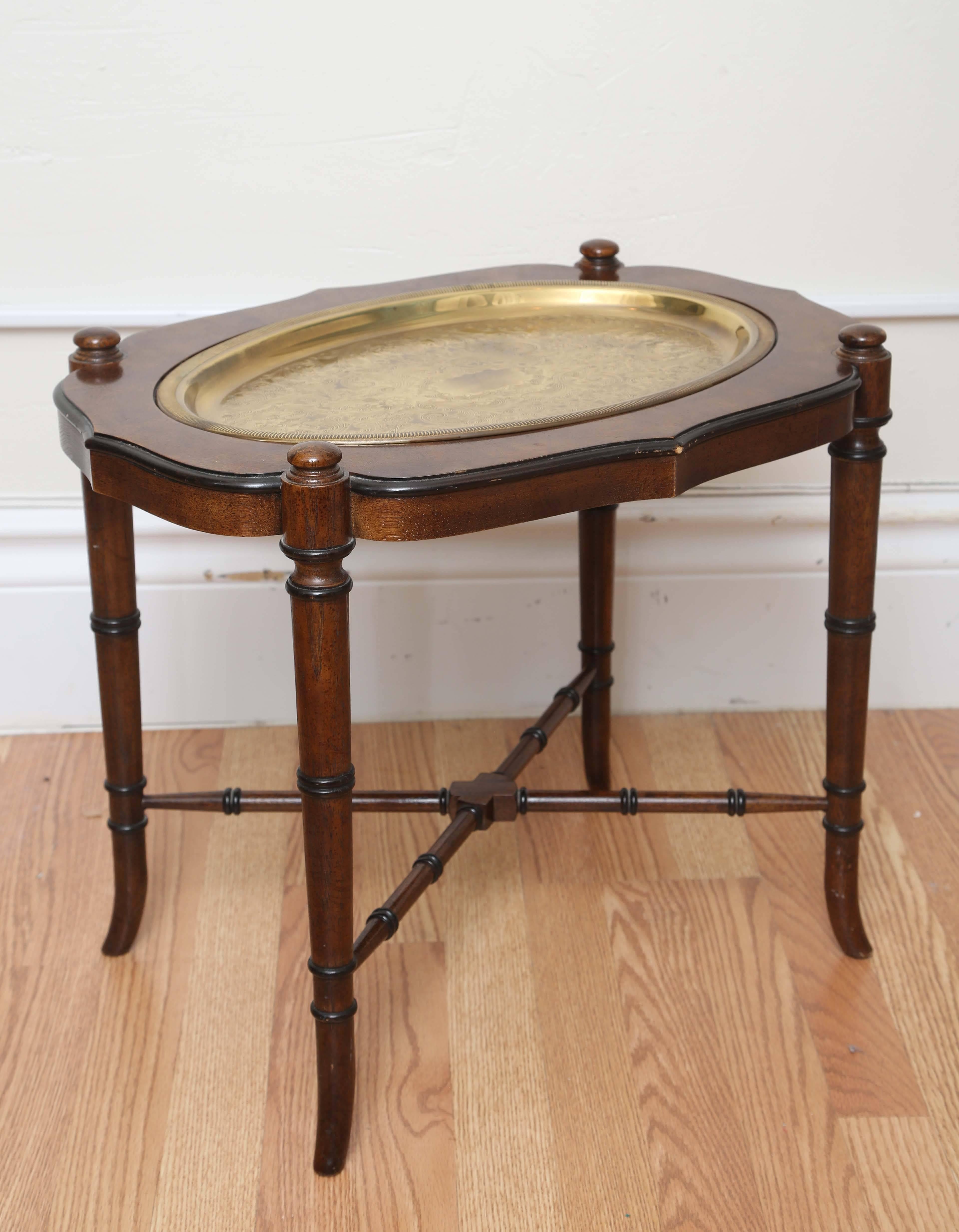 Very sweet wood table with faux bamboo legs and stretchers. Removable brass tray top.