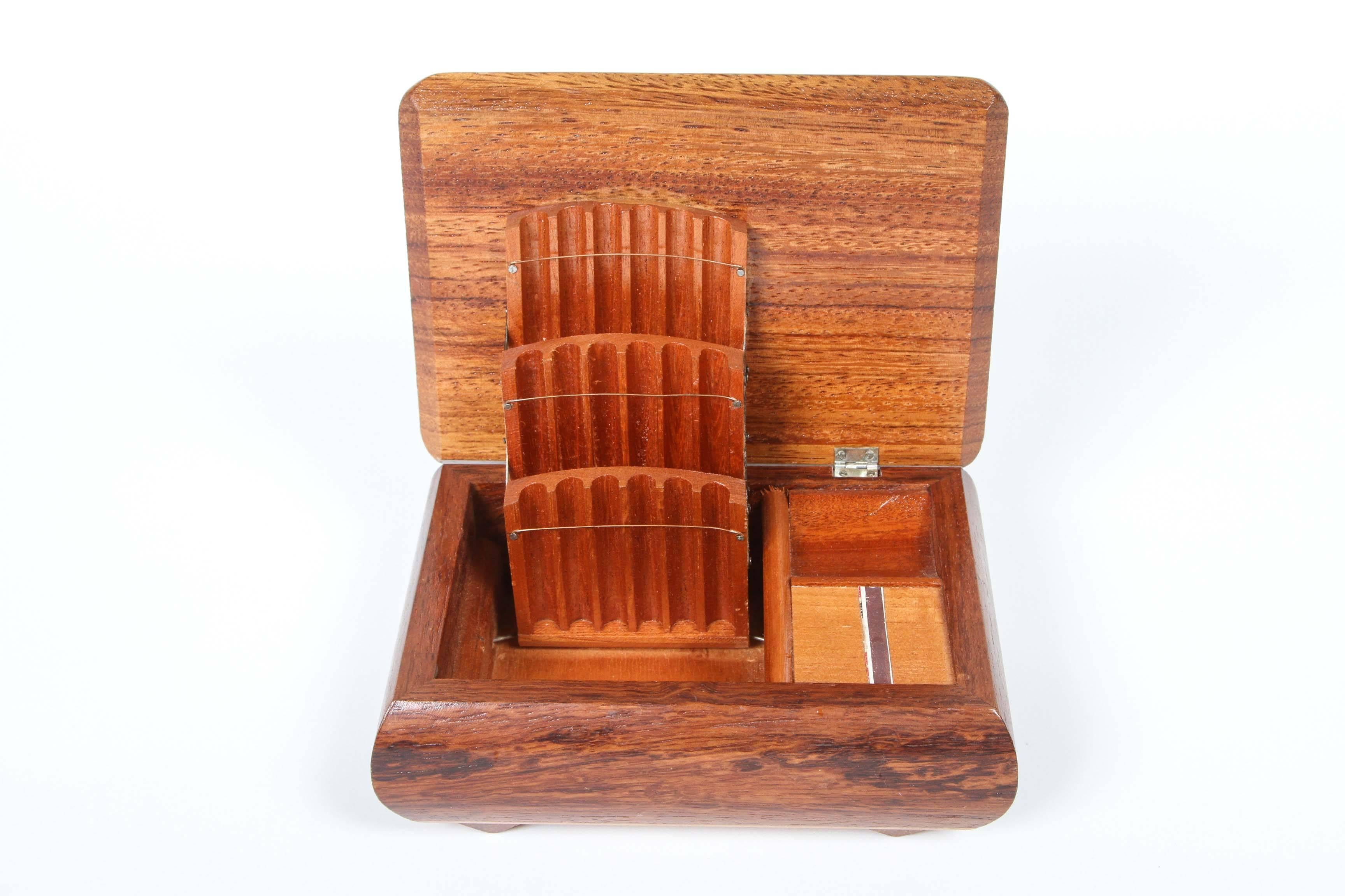 Vintage wood cigarette box with match holder and strike. There are three rows which hold 18 cigarettes and fold in when the box closes.