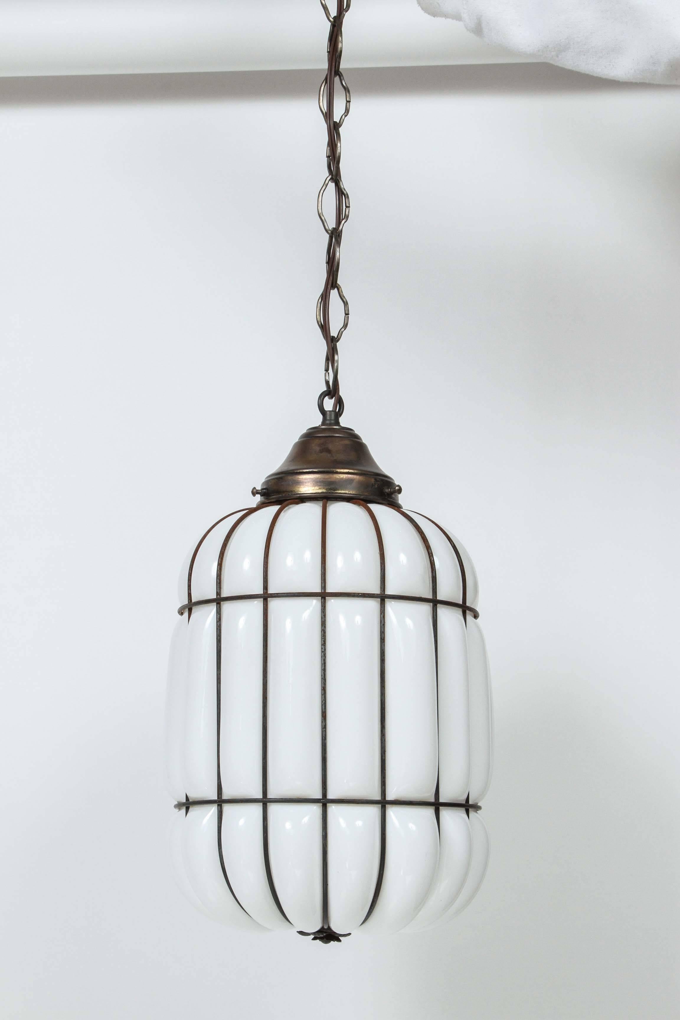 Vintage Art Deco caged milk glass and iron hanging pendant light. Newly rewired with new chain and canopy.