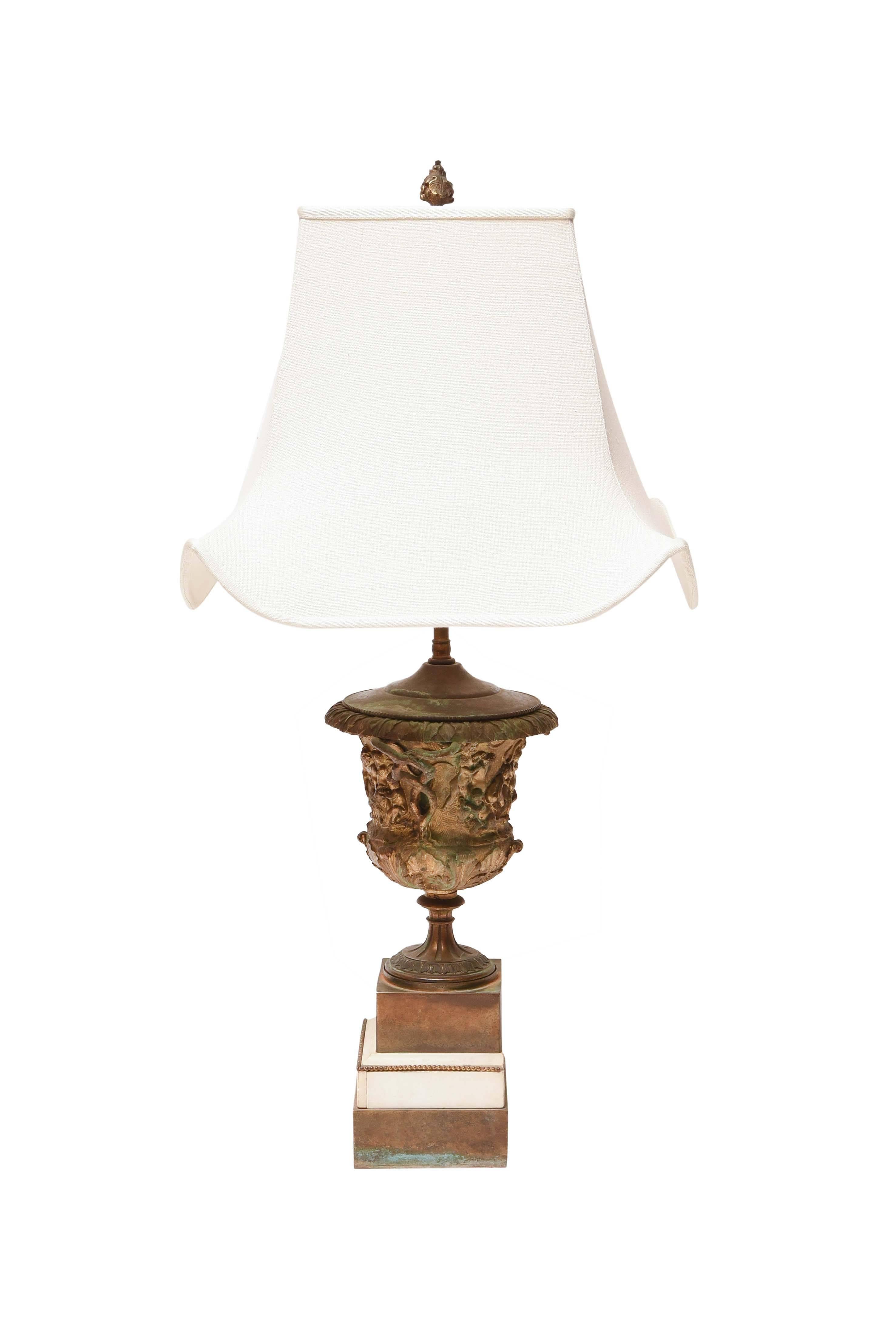 Neoclassic medicei bronze urn table lamp mounted on a marble base.