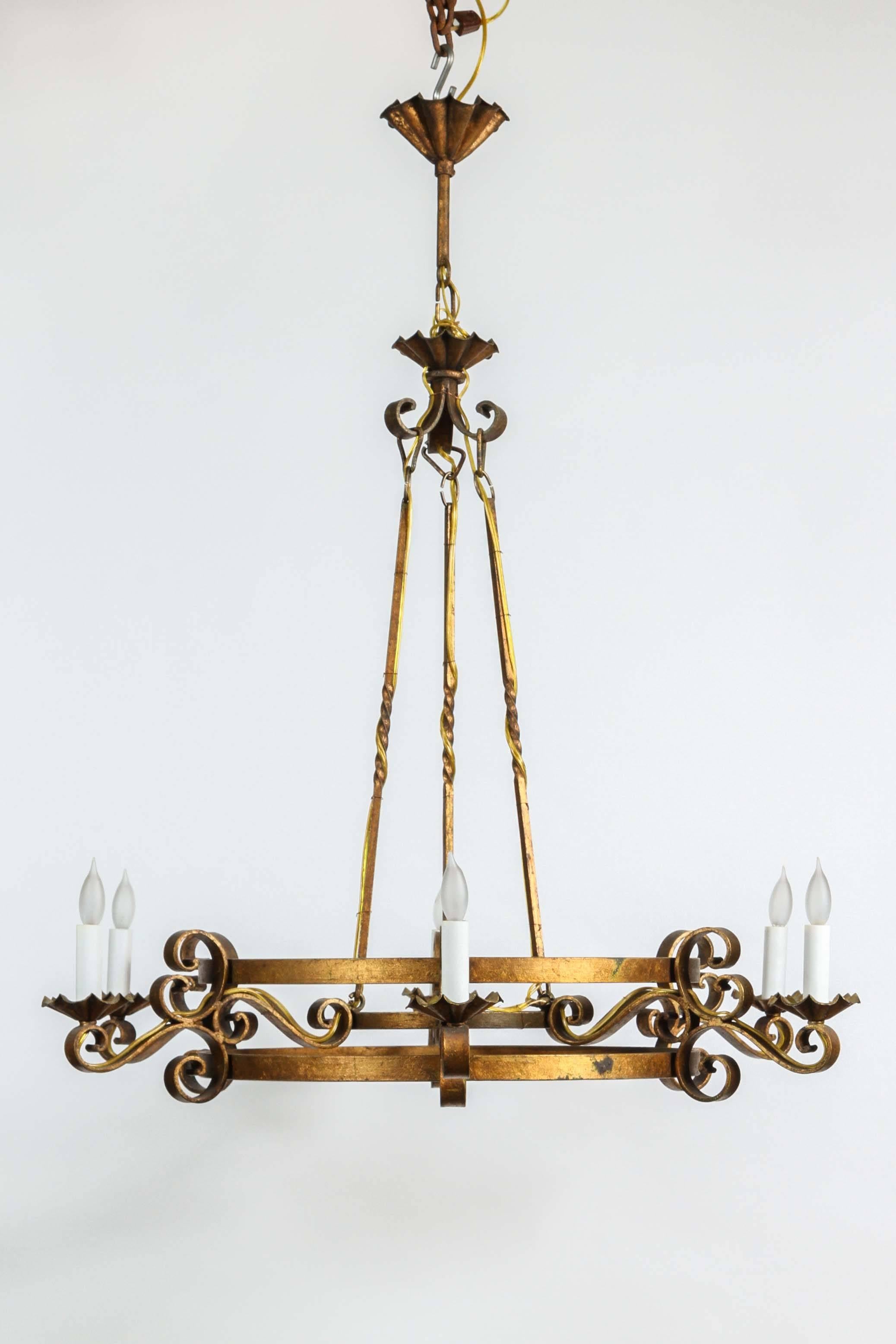 This 1970s wrought iron chandelier has an antique gold finish. Six lights. This can be seen at our 1800 South Grand Ave location in Downtown Los Angeles.