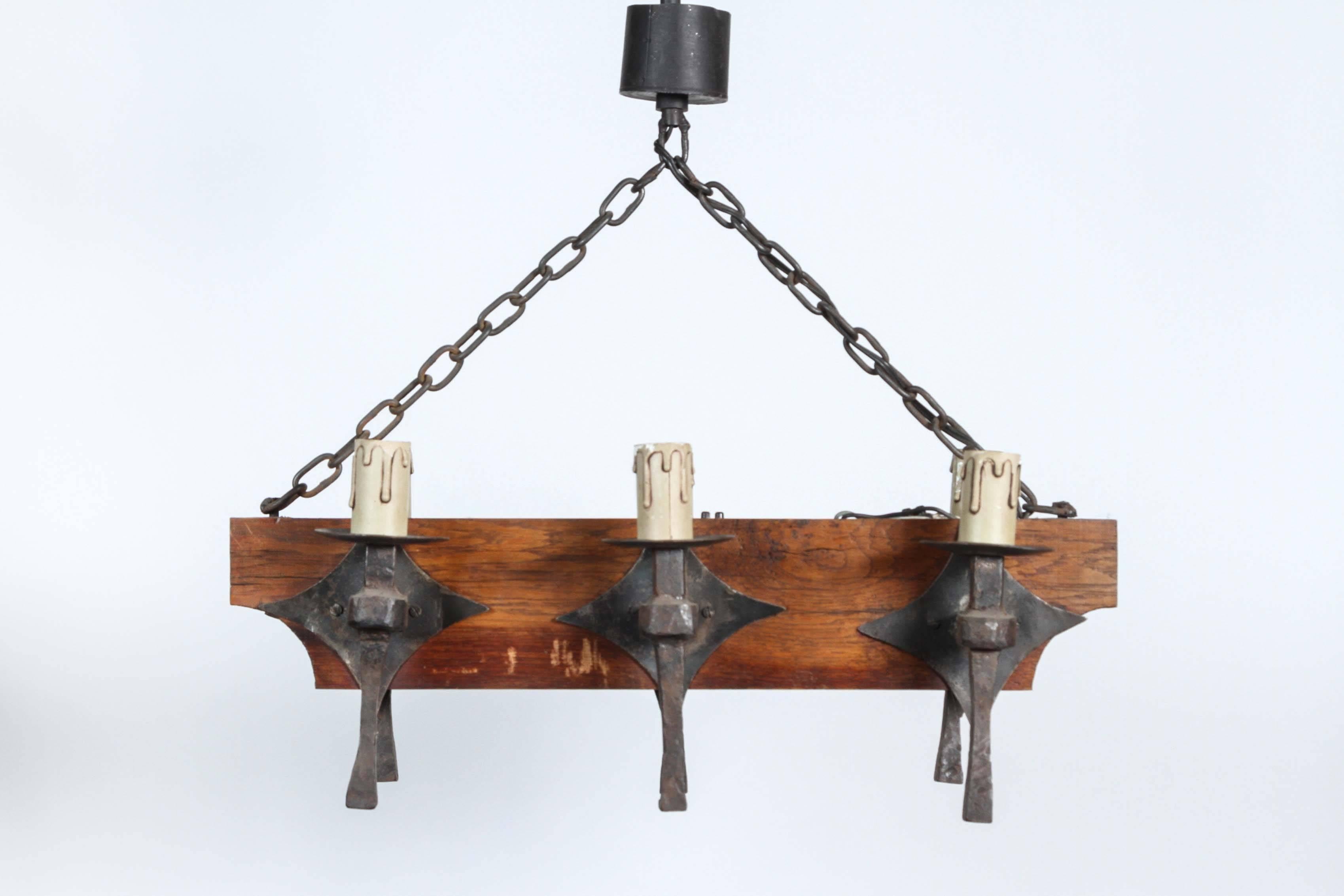 Six-light wrought iron and oak chandelier probably from Belgium or France, age unknown.
