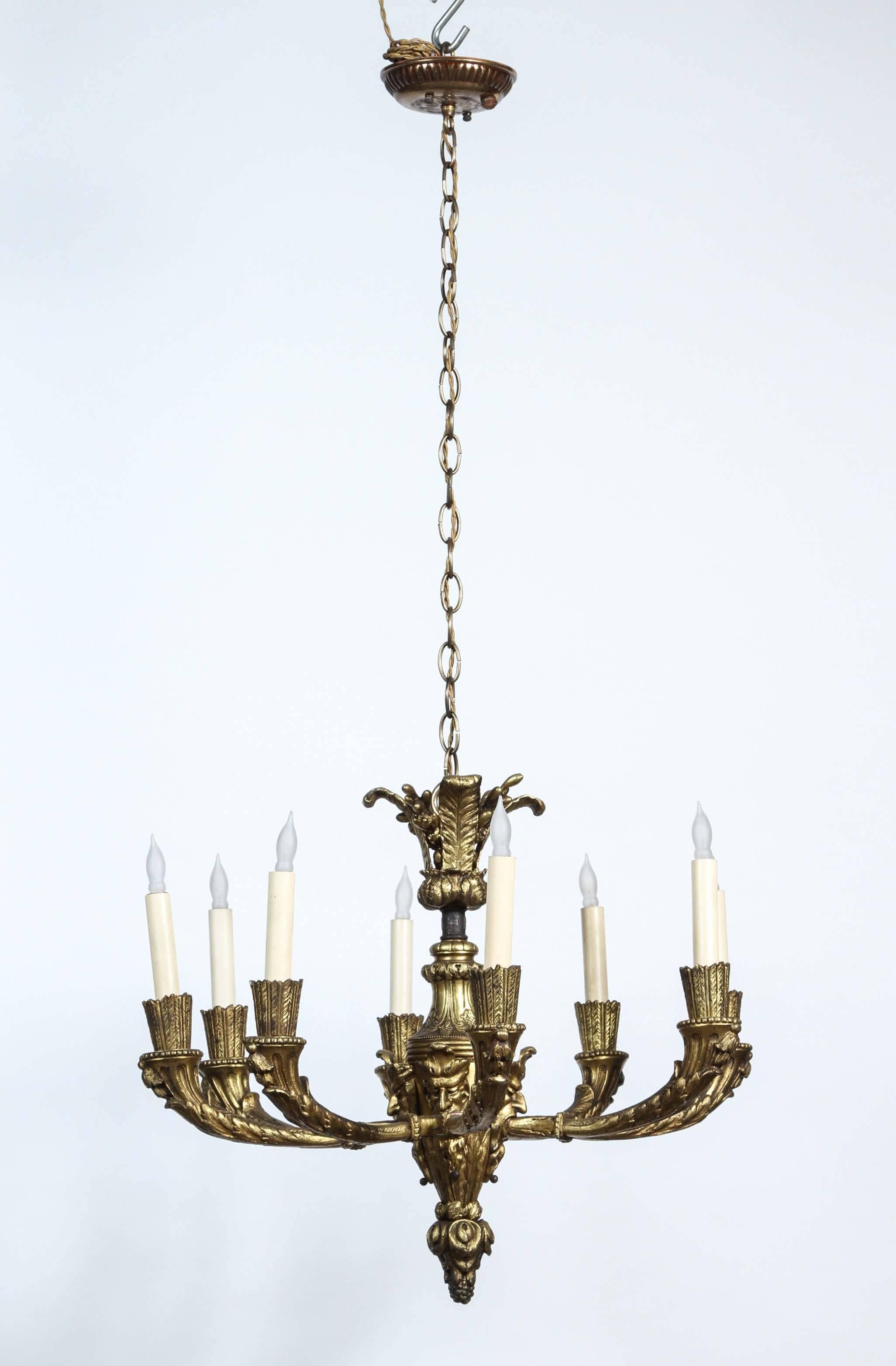 1920s bronze eight-light chandelier with four grotesques from France. Re-wired with new canopy in matching color. This can be seen at our 1800 South Grand Ave location in downtown LA.