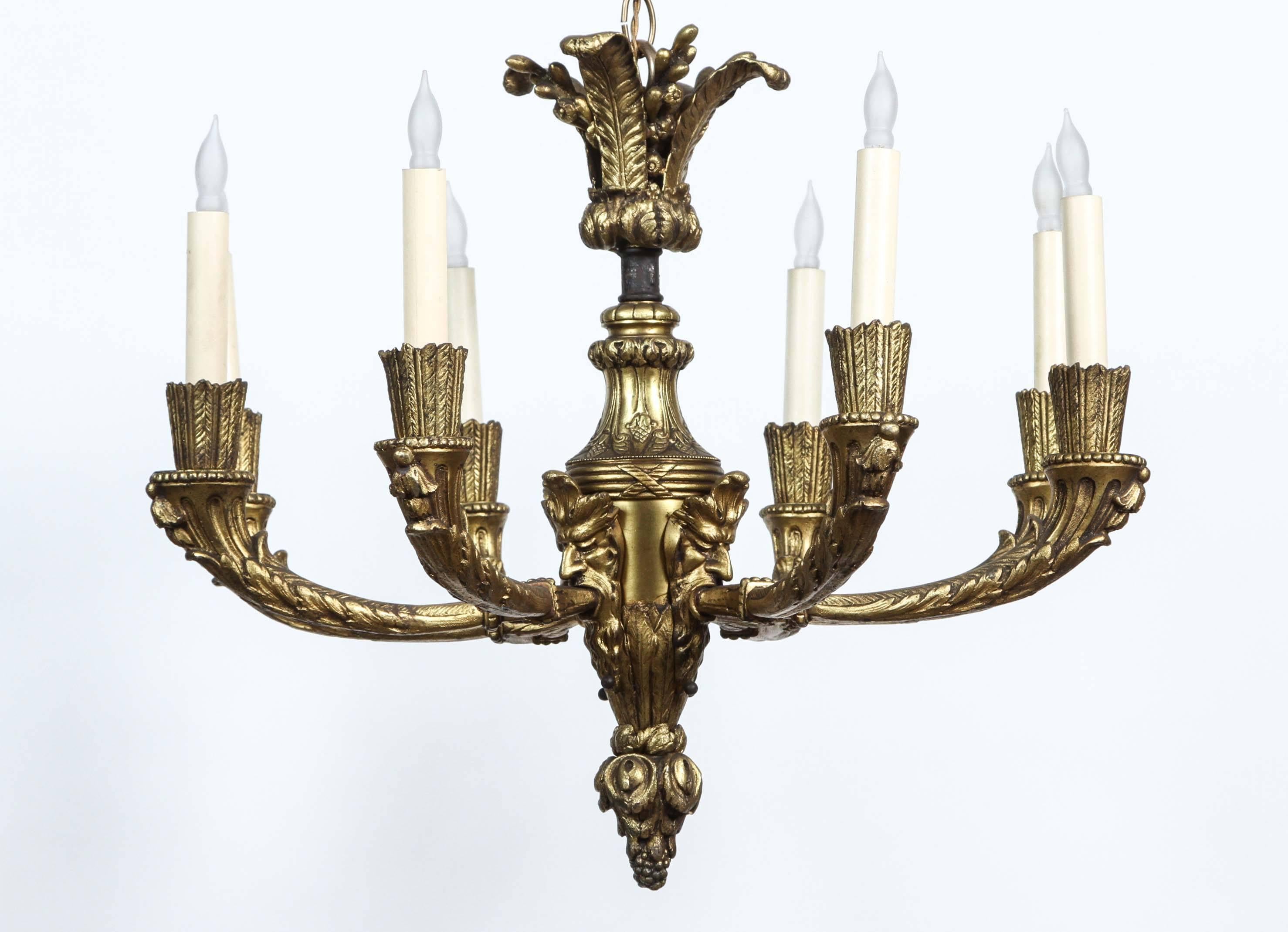 American 1920s, Bronze Eight-Light Chandelier with Four Grotesques from France