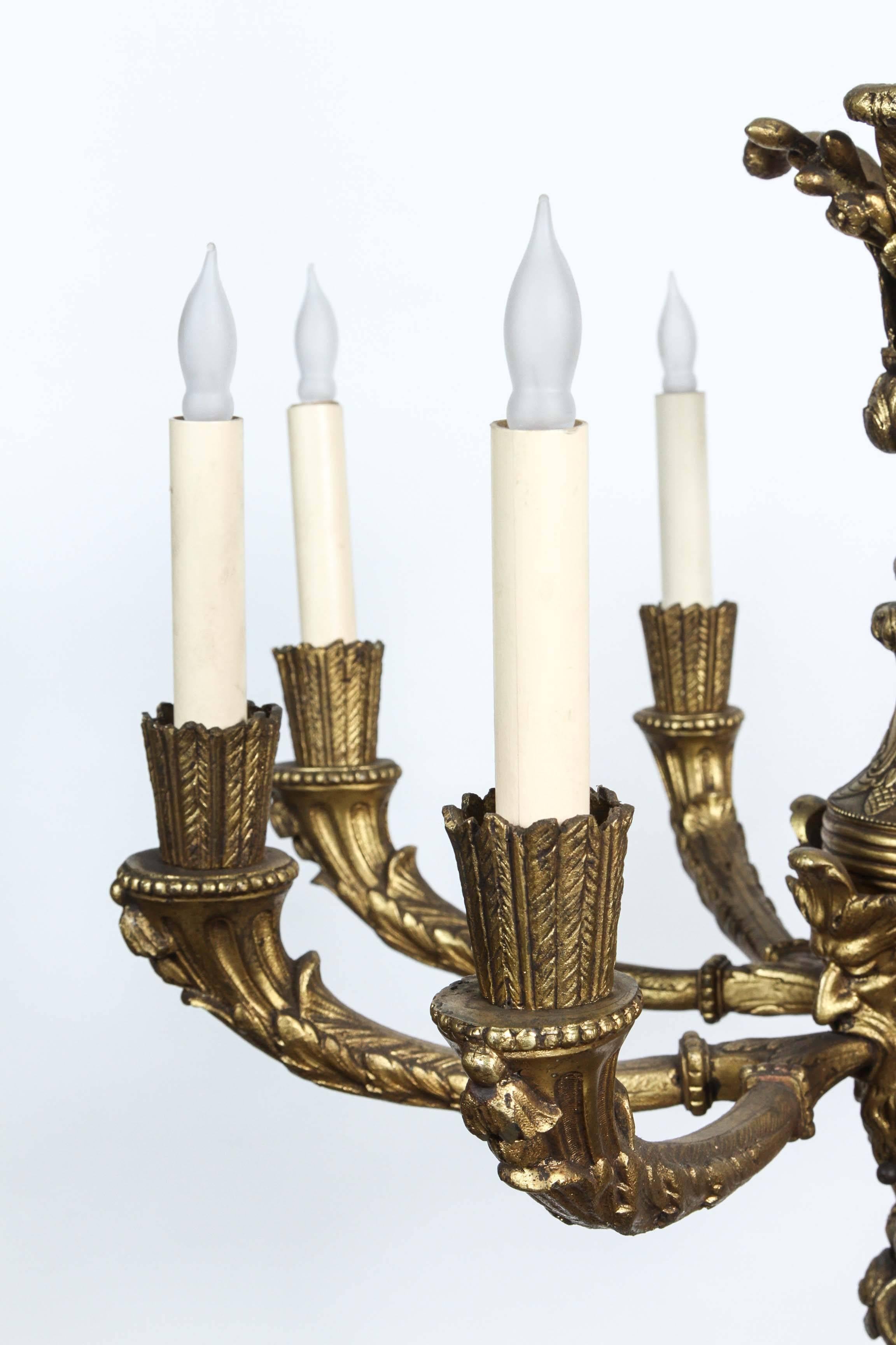 1920s, Bronze Eight-Light Chandelier with Four Grotesques from France 1