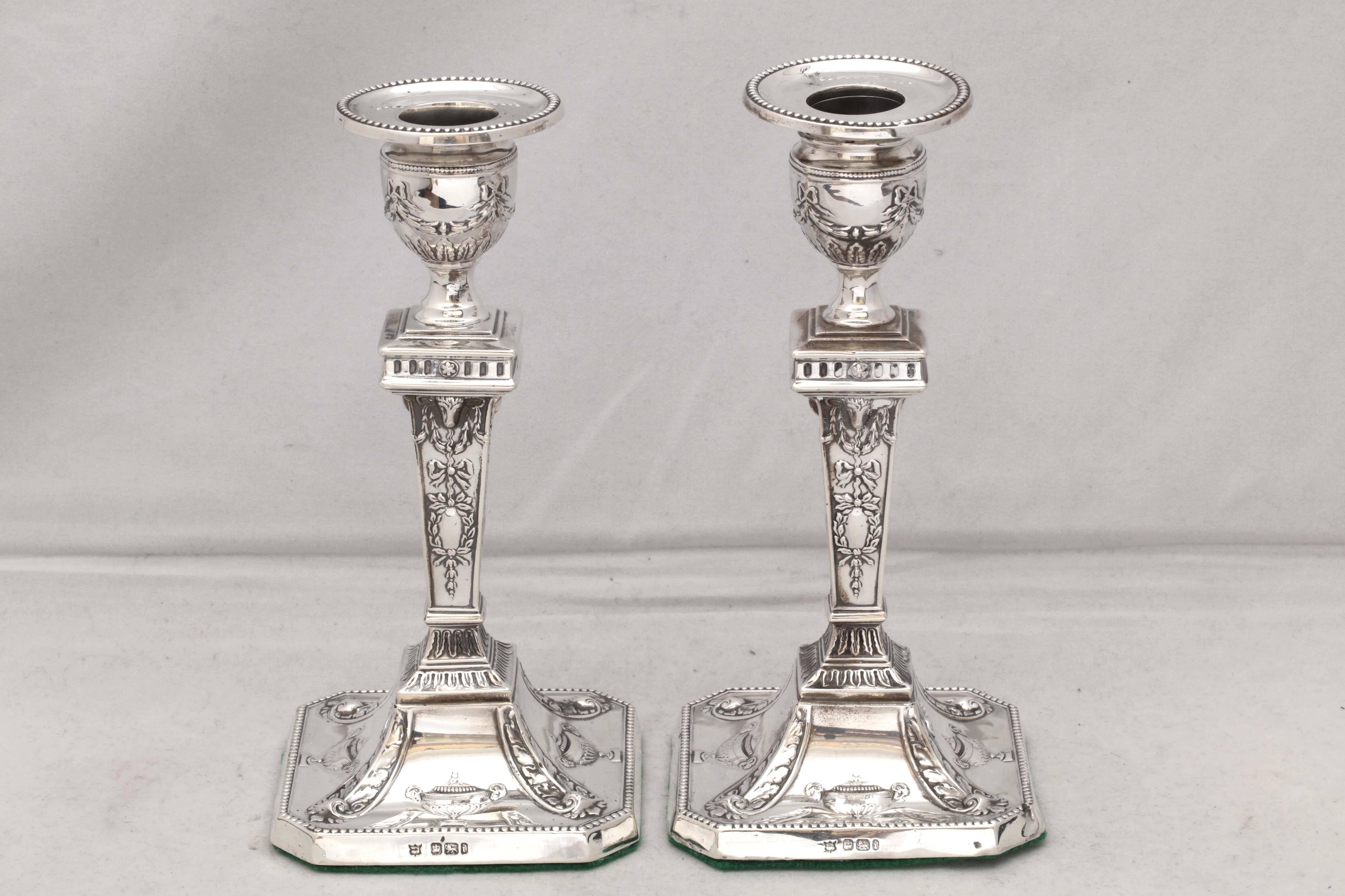 Pair of Edwardian, sterling silver, Adam style candlesticks, Sheffield, England, 1901, William Latham & Son - makers. Octagonal base of each candlestick is decorated with urns and has a beaded border; this & beaded motif is continued on the bobeche