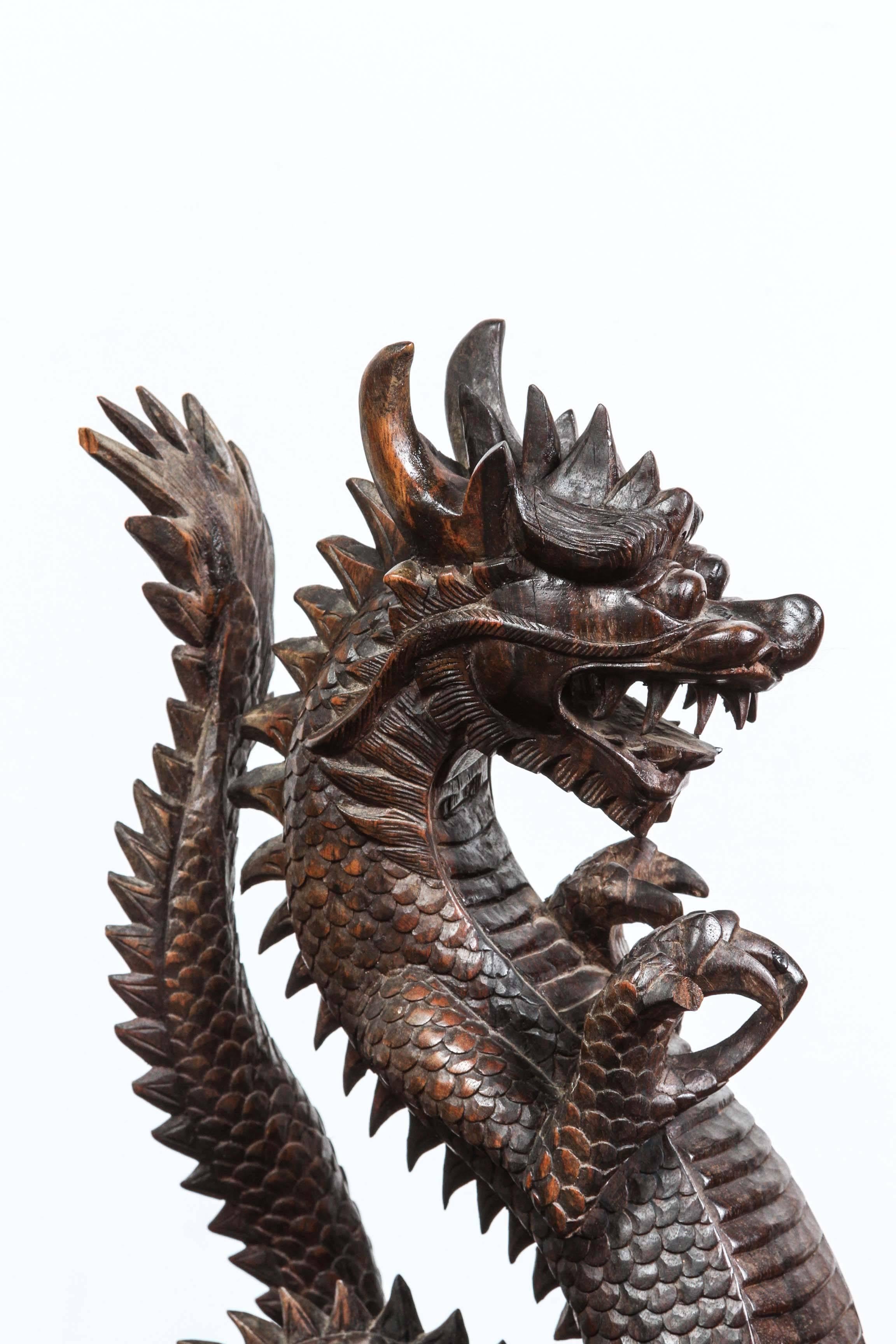 Wooden sculpture of a Roaring Chinese dragon.
Handcrafted with very fine details. 
The sign of Emperor, dragon is the most important symbol of power, leadership and prosperity in the Chinese culture. 
In Asia it is believed that displaying dragon