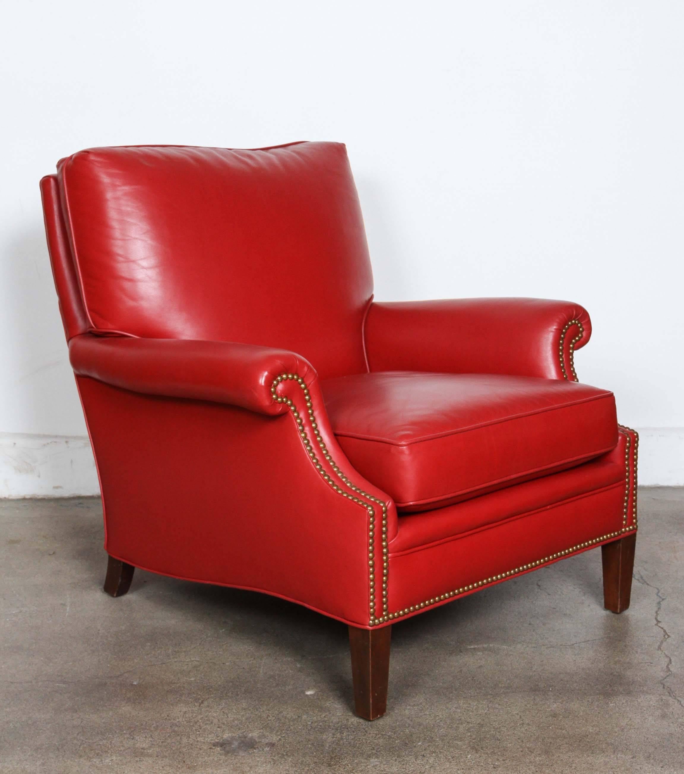 Pair of club leather lounge chairs In a deep Moroccan red leather, very comfortable.
Brass nailhead studded in front and back, loose cushion seat.
Hot Moroccan red armchairs with the elegant French European look.
Great library club lounge chairs.
