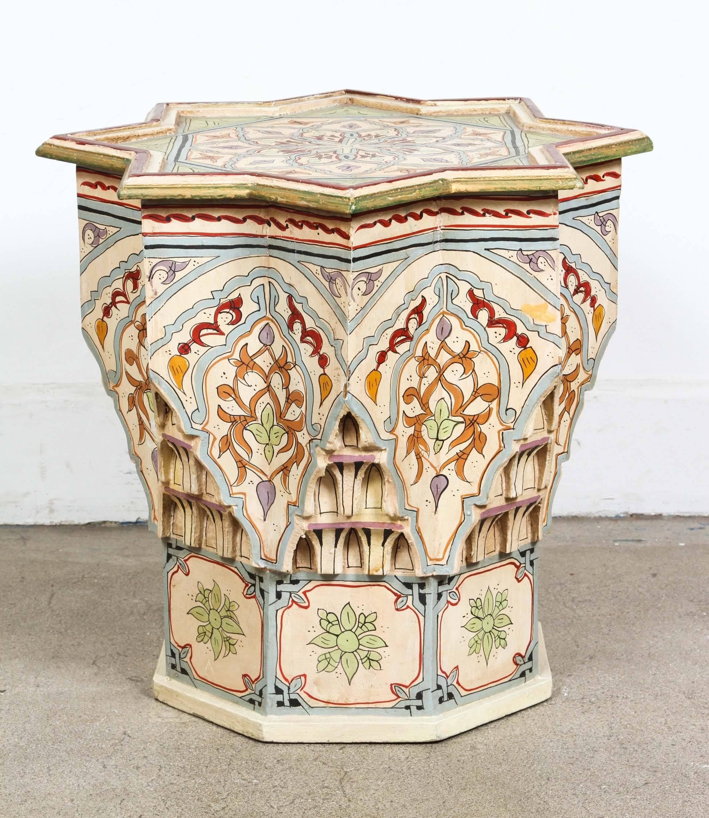 Vintage Moroccan wooden hand-painted and carved side occasional table with Moorish designs.
Hispano Moresque style in ivory background color with multicolored red and sage floral and geometric designs.
Very decorative side table fine artwork on a