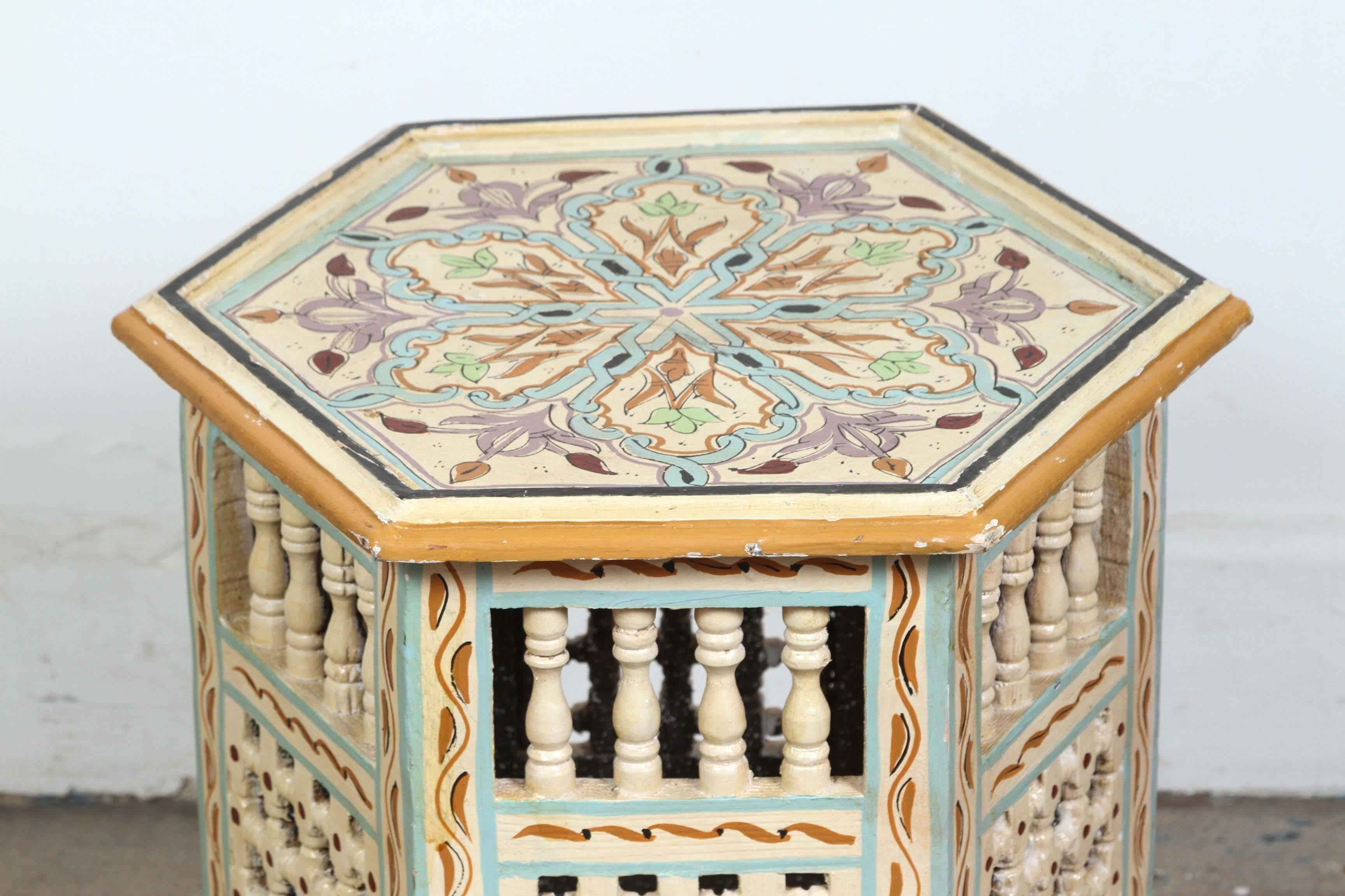 Hexagonal shape, Moroccan vintage side table hand-painted on ivory background, floral and geometric designs and moucharabie cutout on the sides with Moorish arches.
handcrafted in Morocco by skilled artisans.
A pair is available price is for one,
