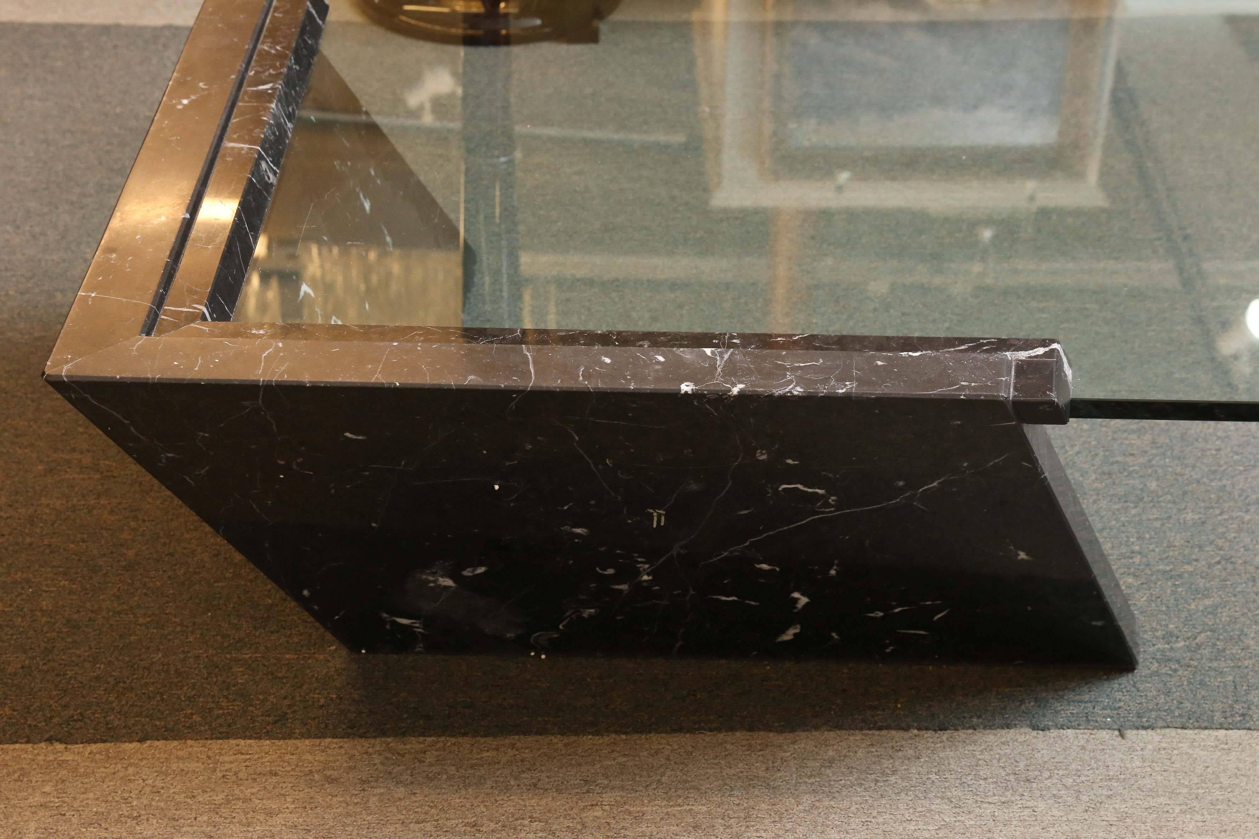 Very unique coffee table is composed out of great glass top and marble base. The base is holding only one corner of the table, but it gives a great support and stability. 

 Italian, circa 1930s.
Measures: 50” W x 50” D x 16” H.
 Condition is good.