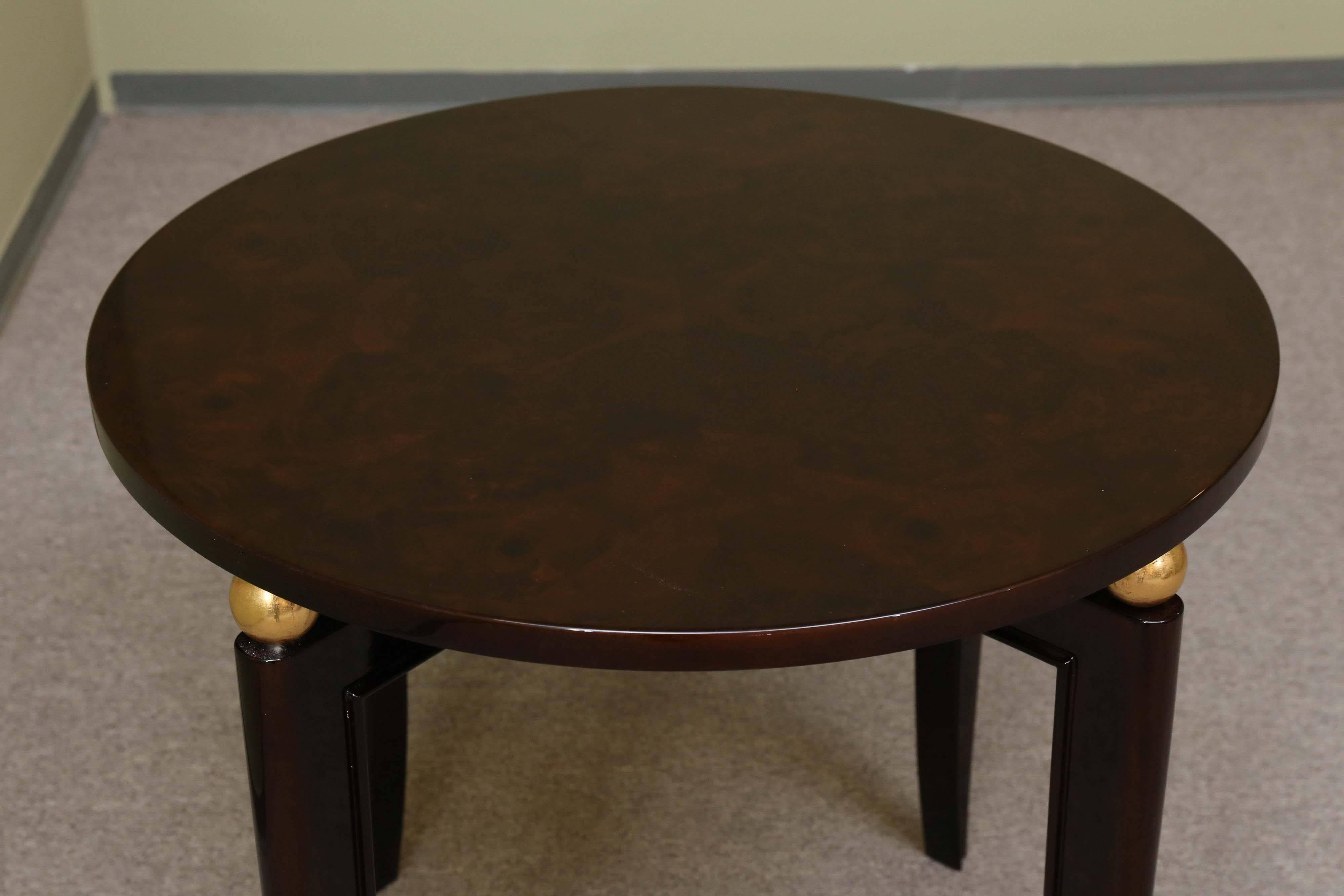 The round tabletop is resting on four supporting metal spheres, that are attached to the 4 elongated slightly curved legs. Under the tabletop, legs are connected to each other in the middle. 


 France, circa 1930s.
Measures: 30” W x 26” H.
 