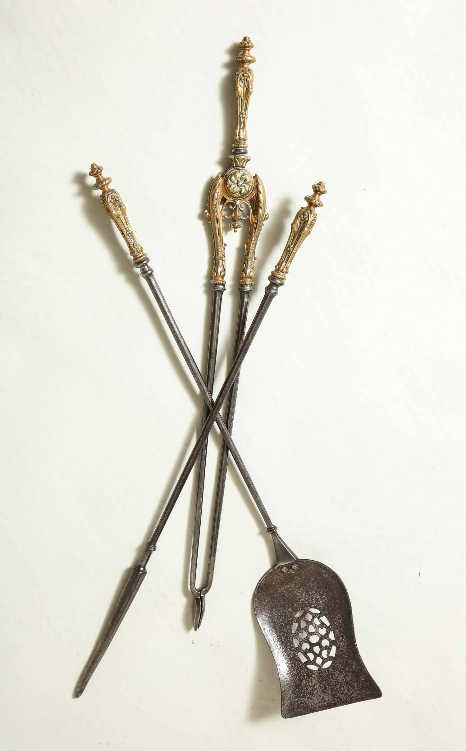 Very fine set of mid-19th century bronze handled steel fire tools, the elaborately cast handles with foliate designs, the shaped dished shovel with oval pierced design, all with nicely patinated surface.