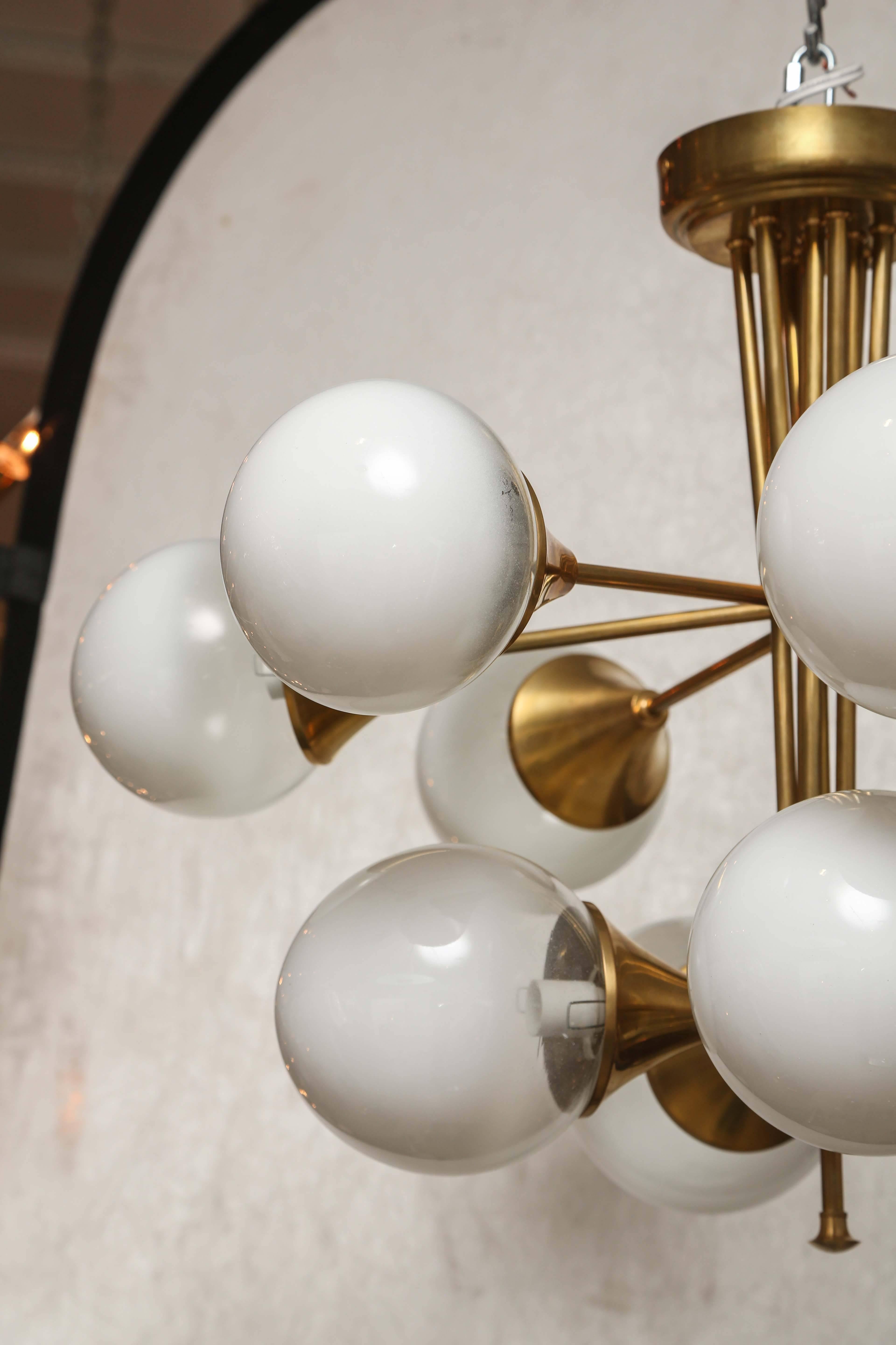 Retro variation on a traditional Sputnik this fixture has brass armature with ten satin glass heads projecting from central stem.