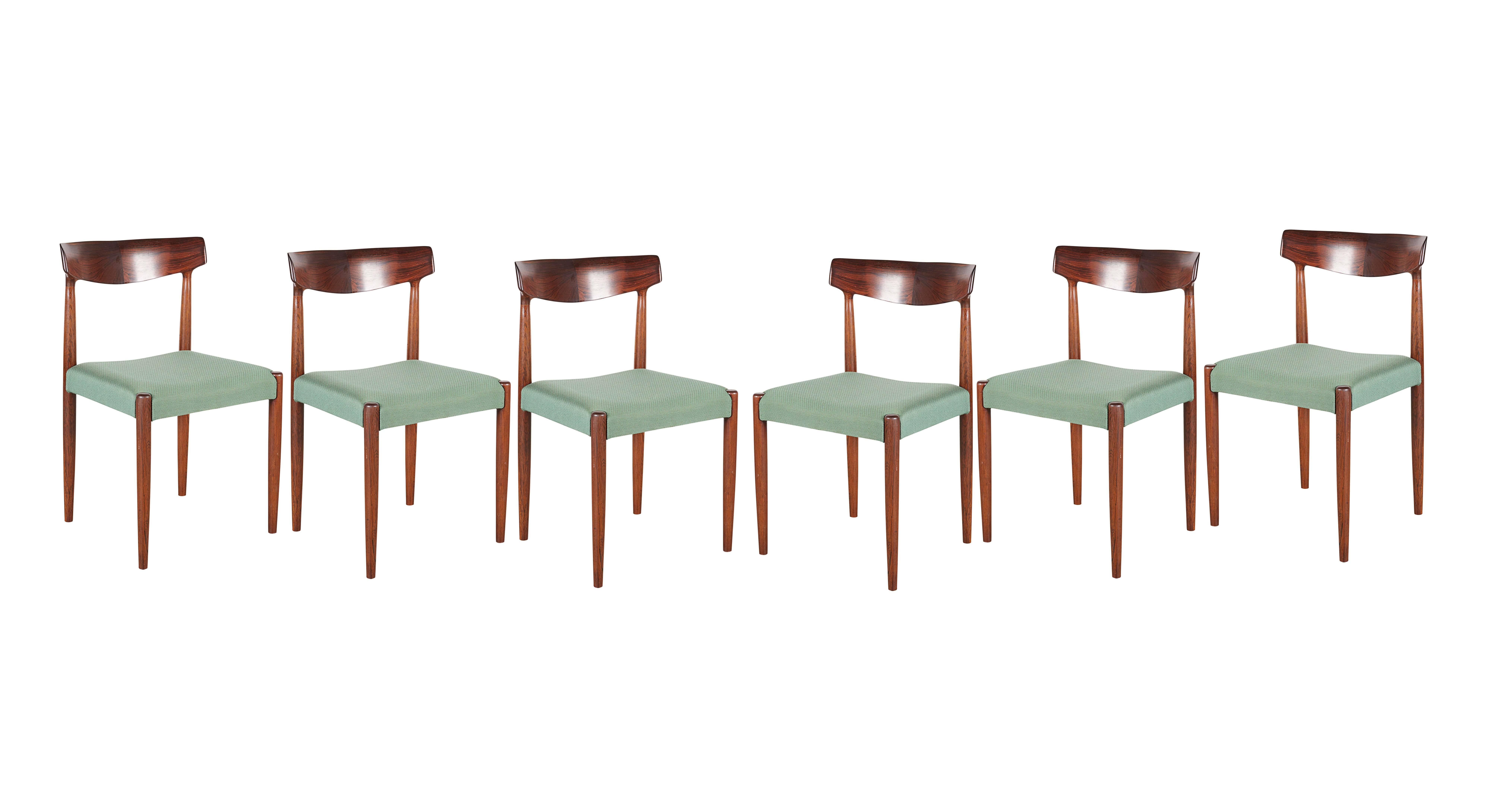 Mid Century 1960s Rosewood Dining Chairs by Knud Faerch

This set of vintage dining chairs are in excellent condition, comfortable, and absolutely beautiful. Knud Faerch's signature butterfly back support really makes these chairs shine. The fabric