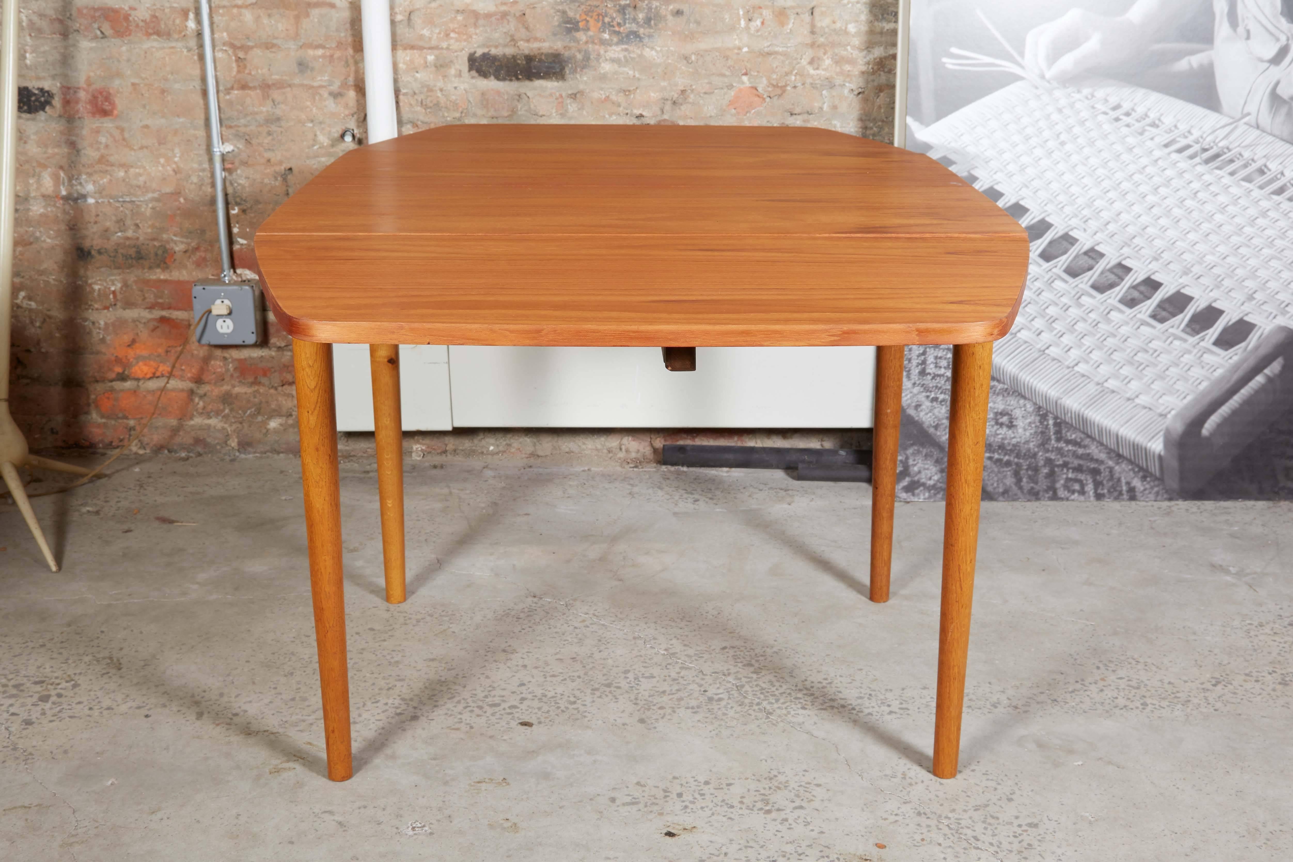 1960s Danish Teak Dining Table with Drop Leaves

This mid century teak drop leaf dining table's atomic shape is so rare. The table expands to 59.25' with the leaves up, but the leaves don't only drop they are removable. The smallest size of the