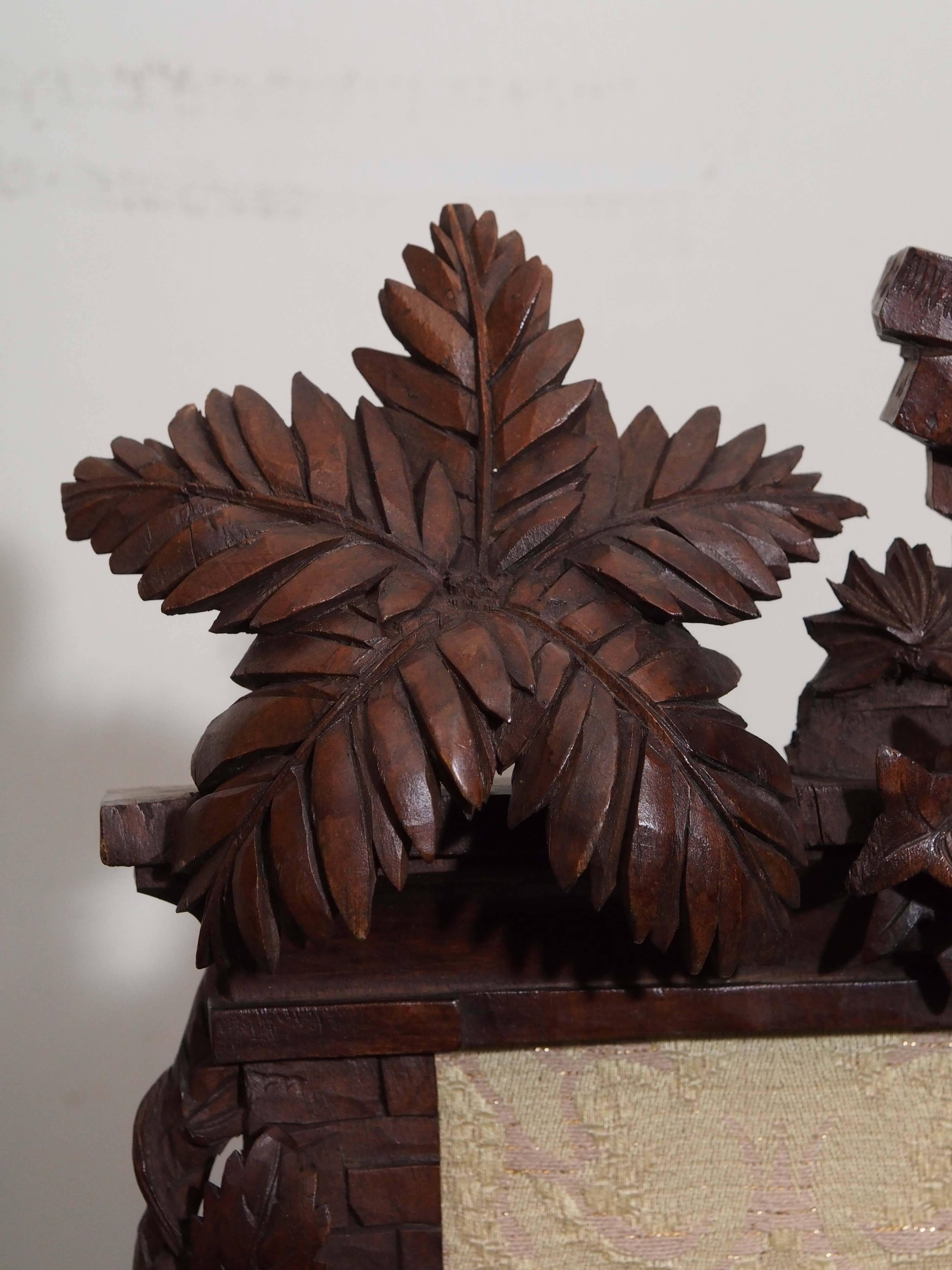 19th century black forest frame carved with motif of running and vines. Has self easel.