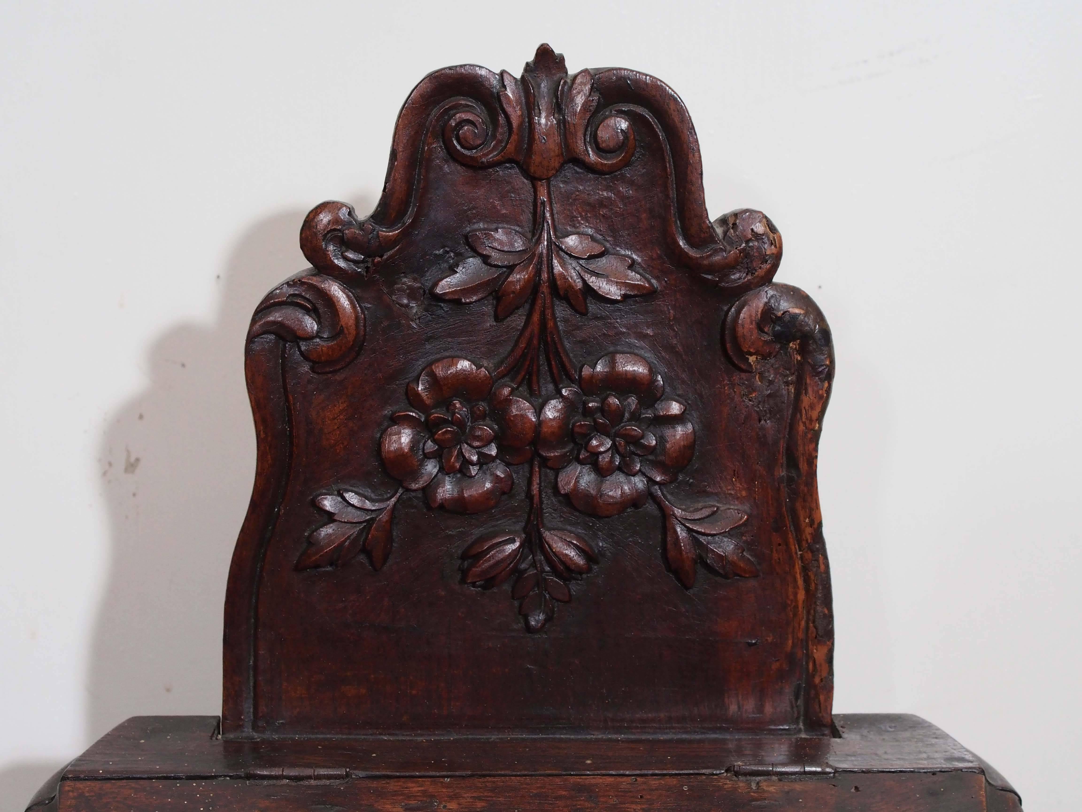 Exceptional French bombe form carved walnut salt box with drawer for nippers. Hinged lid and back splat. With traditional sunflower motif of the Provence region. Of the Louis XV period.