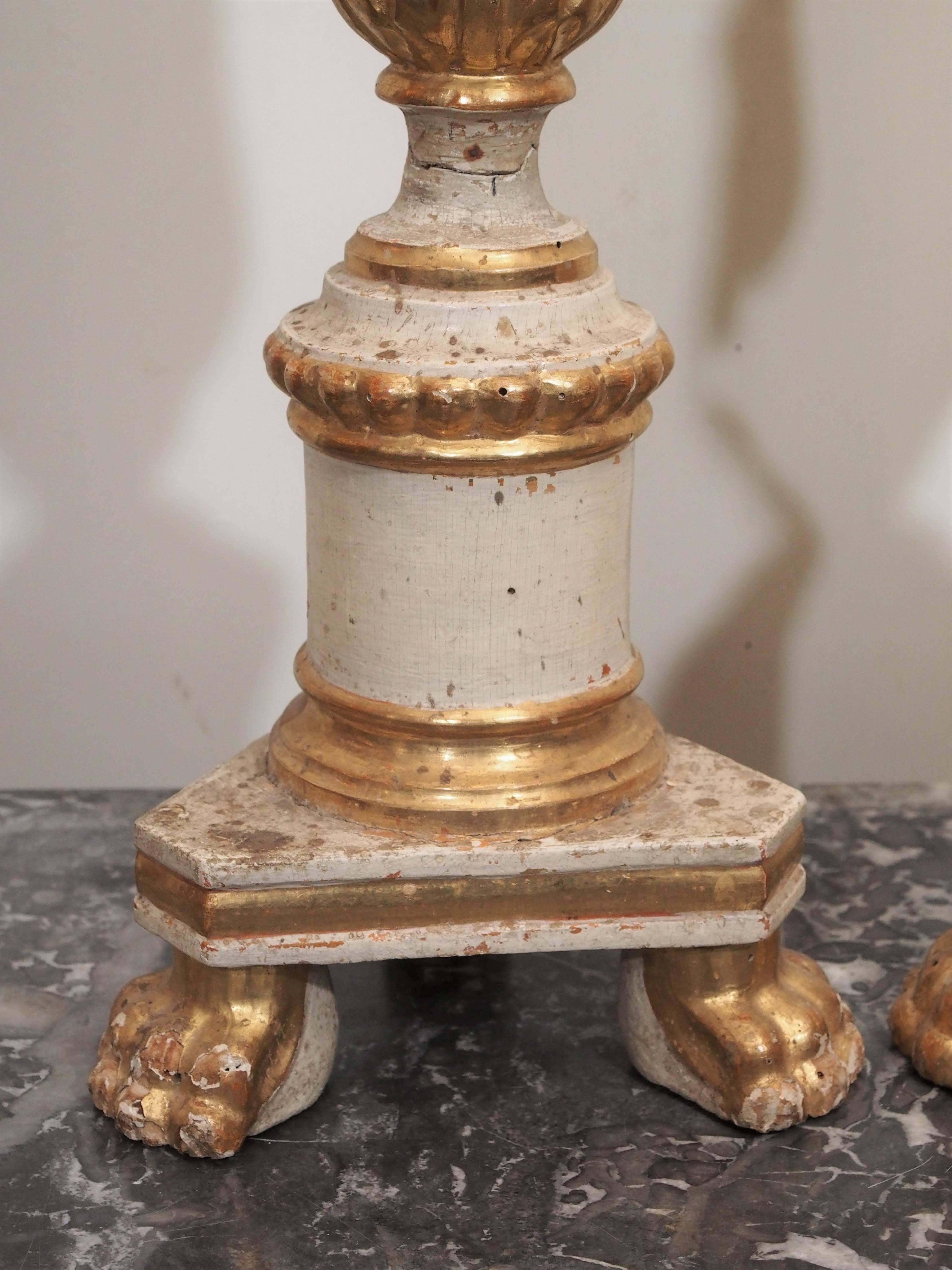 Pair of Italian painted and parcel-gilt Louis XVI style Altar pricket candlesticks with paw feet.