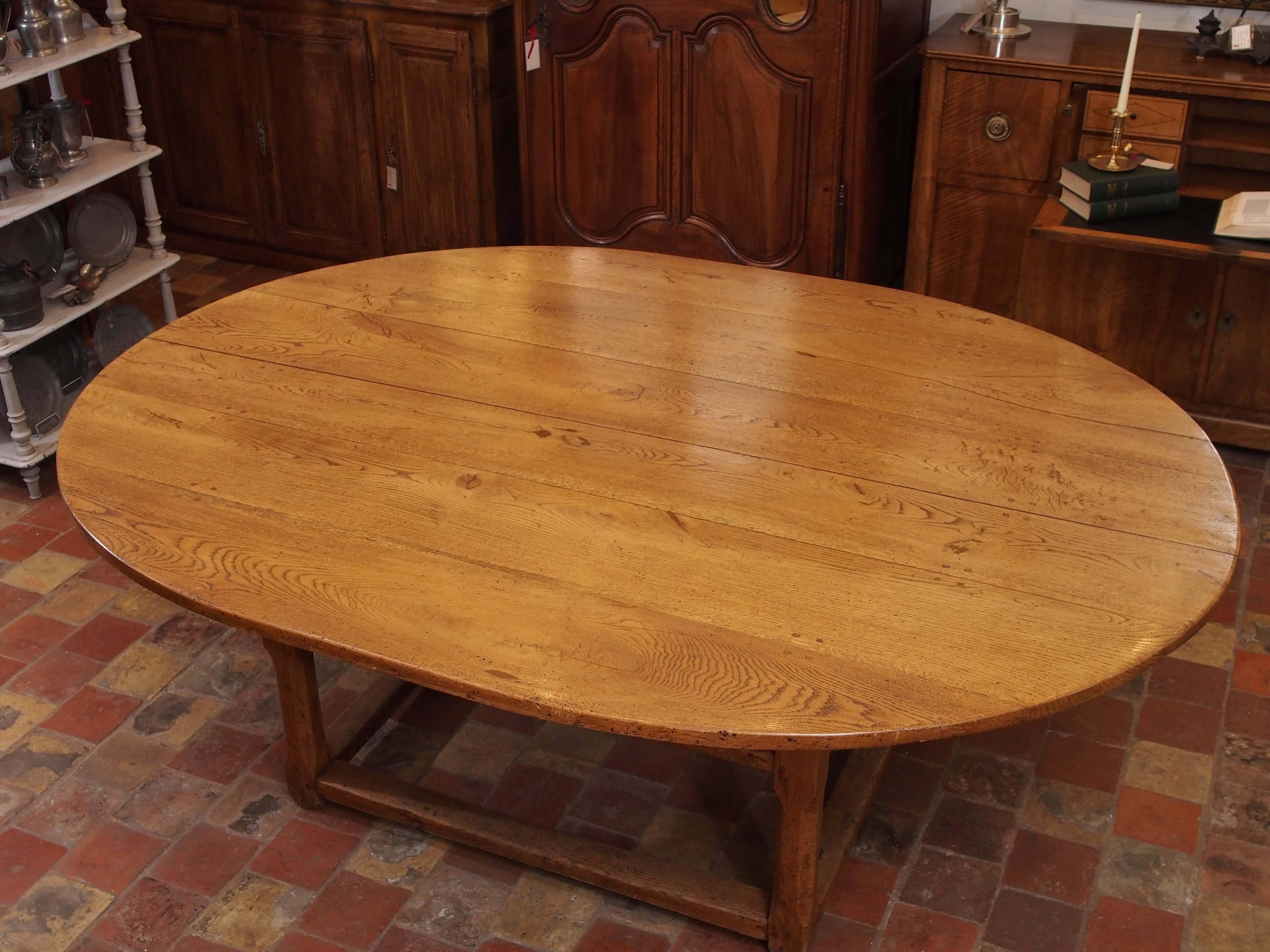 19th century French Louis XIII style oak elliptical dining table with two drawers from Haute Provence.