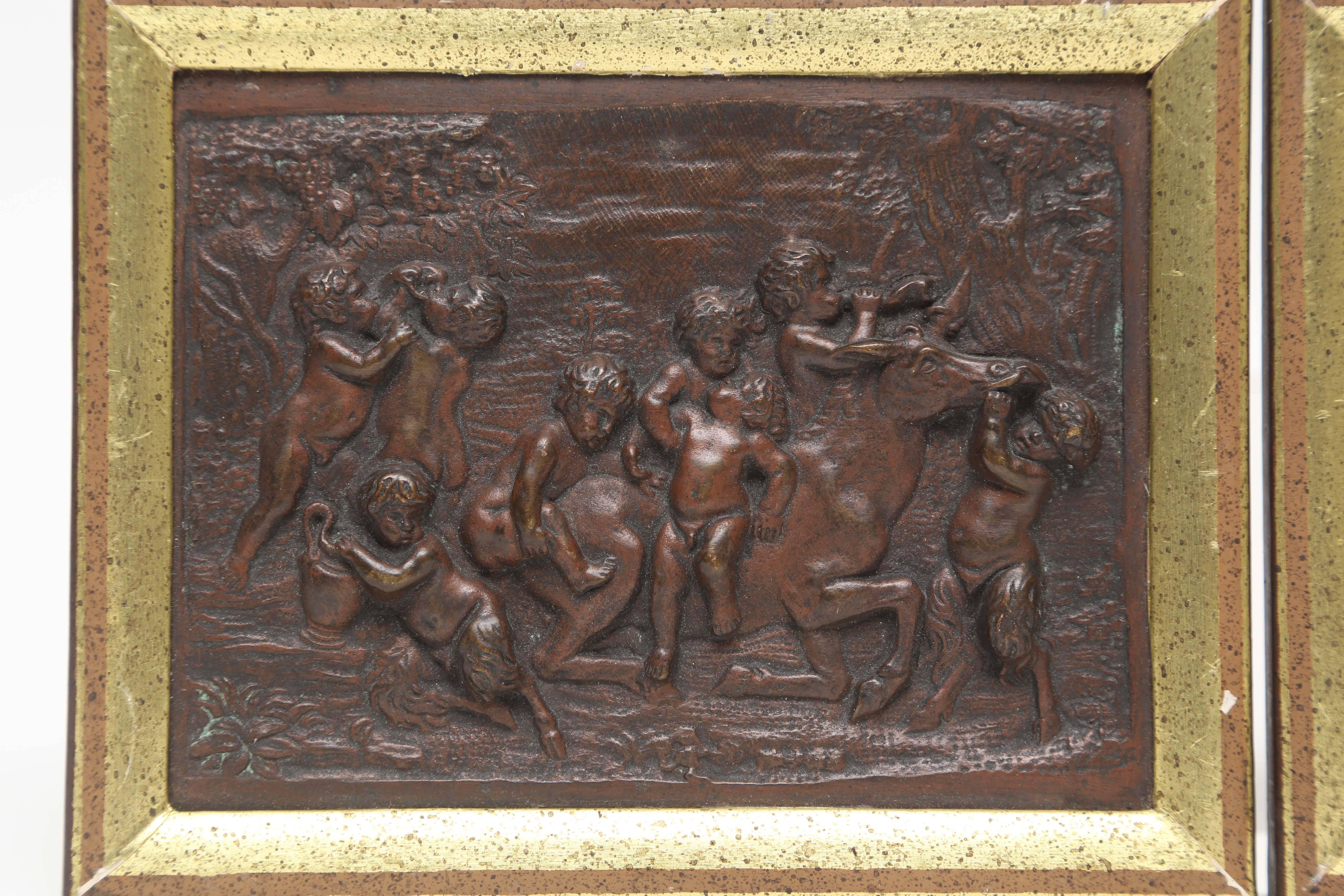 In the first plaquette the putti drink wine, eat grapes, make music and wrestle in a field with a round temple in the background. Signed CLODION

In the second plaquette, young satyrs and putti drink wine and play with a seated horse in a forest
