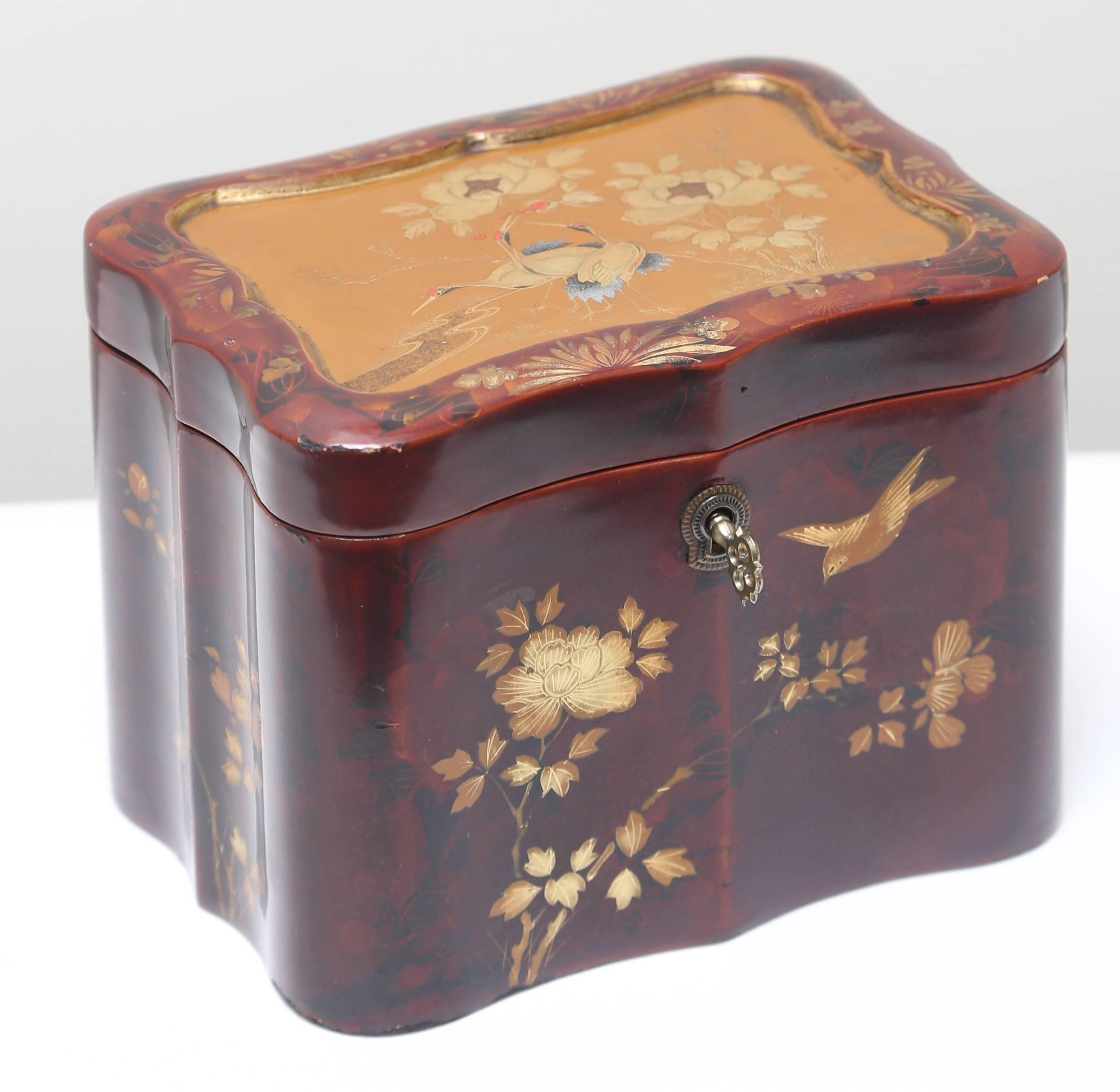 Beautiful red lacquer decorated with birds. Wonderful undulating design. Original key intact.
