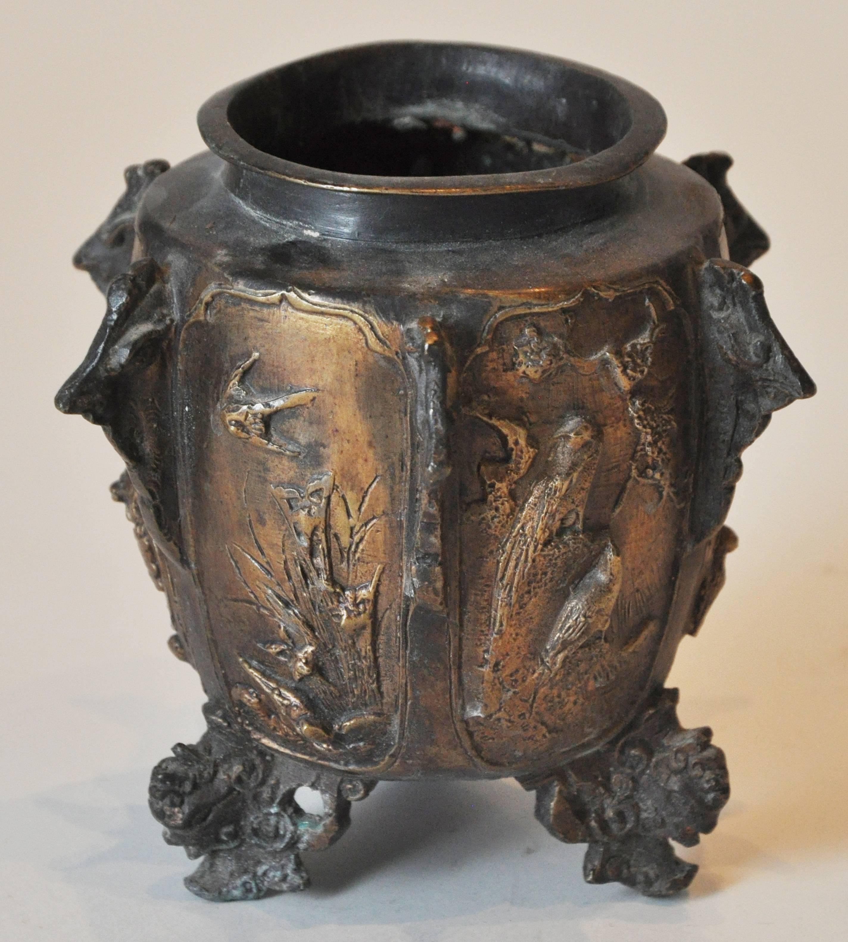 19th century German bronze footed urn. Features gargoyle feet and six natural scenes of birds divided by projected intricacies.

Dimensions: 6
