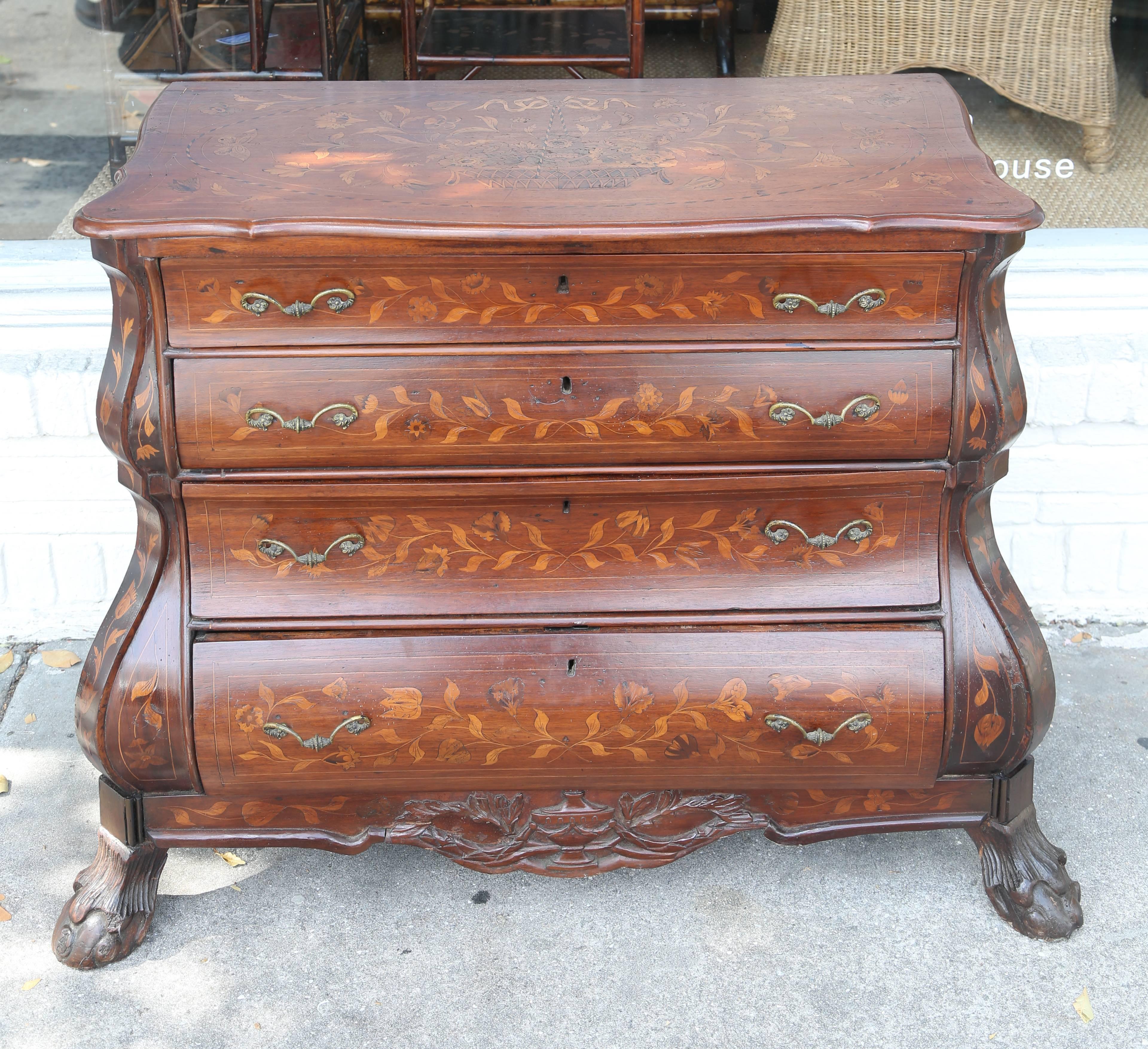 Superb mahogany Dutch marquetry chest of drawers on ball and claw feet. It dates to circa 1860. There is a small crack down the one side but looks fine. This piece is all original and has solid oak drawer linings.
The brass handles are all original