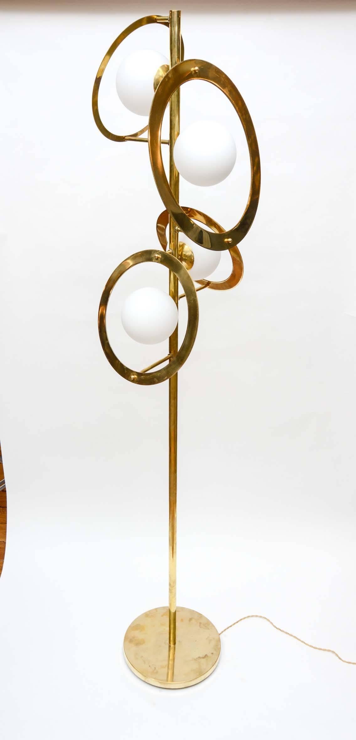 Pair of Saturn design floor lamps by Glustin Luminaires.

Brass feet, central stem and decorative rings, four sources of lights in the Murano glass globes.
