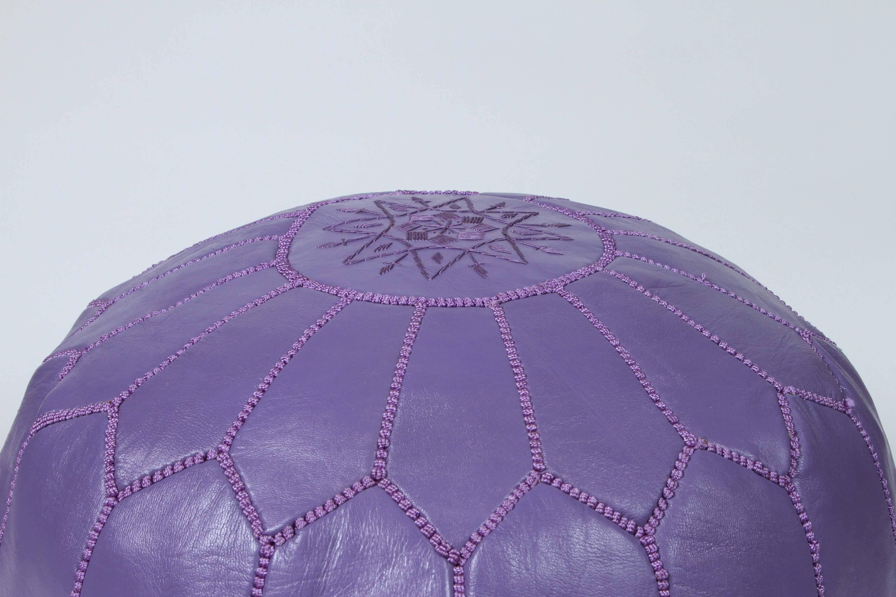 Moroccan handcrafted leather ottoman, with embroideries.
Could be used a foot stool or side table or ottoman.
The Moroccan leather poufs are hand-tooled by artisans and embroidered with silk tread.
Very nice handmade Moroccan lavender color