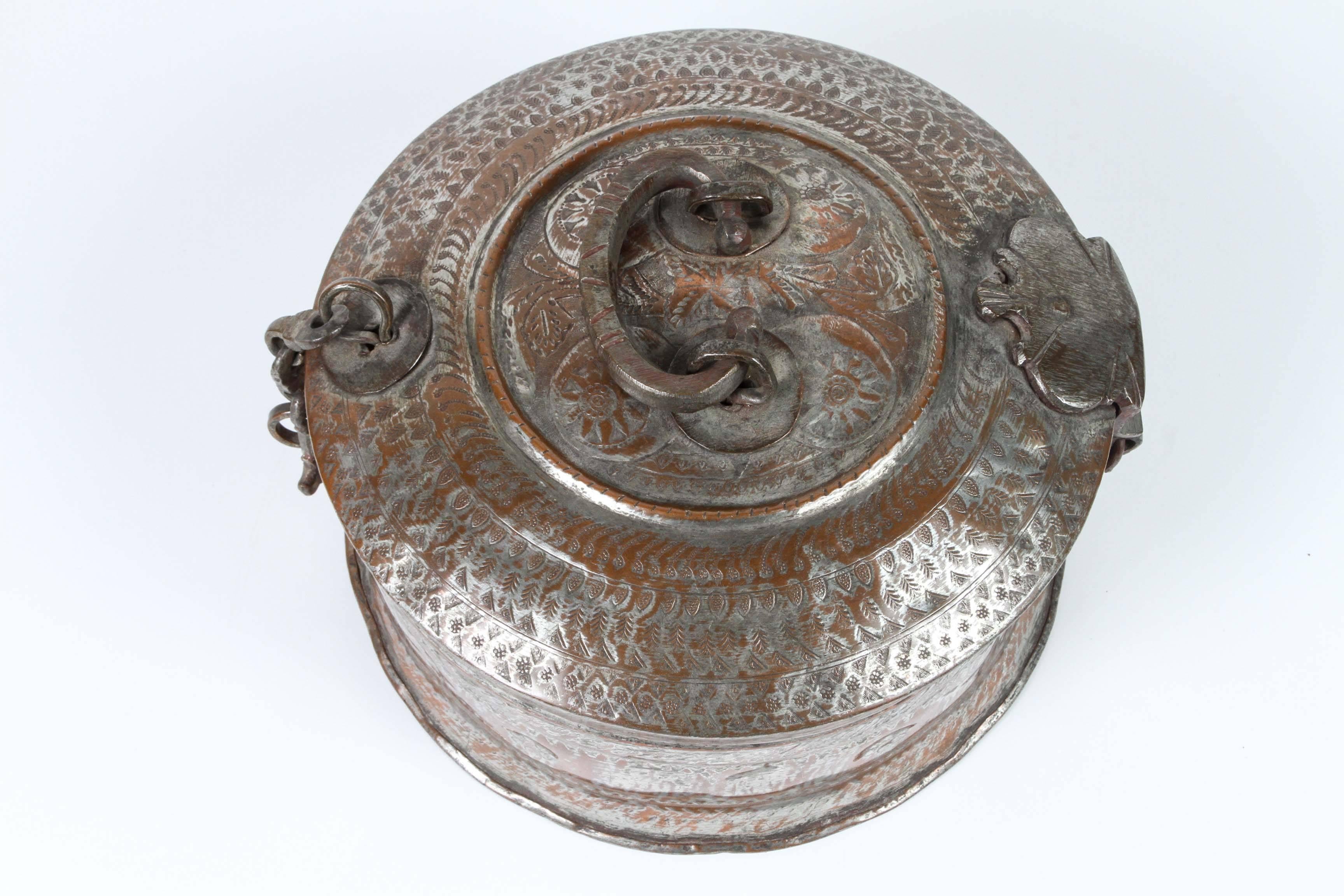 Beautiful handcrafted decorative round tinned copper bronze Asian box with lid, latch and handle.
Tinned copper Indian vessel delicately and intricately hand-hammered with floral and geometric designs.
Beautiful vintage bread / roti dabba box with a