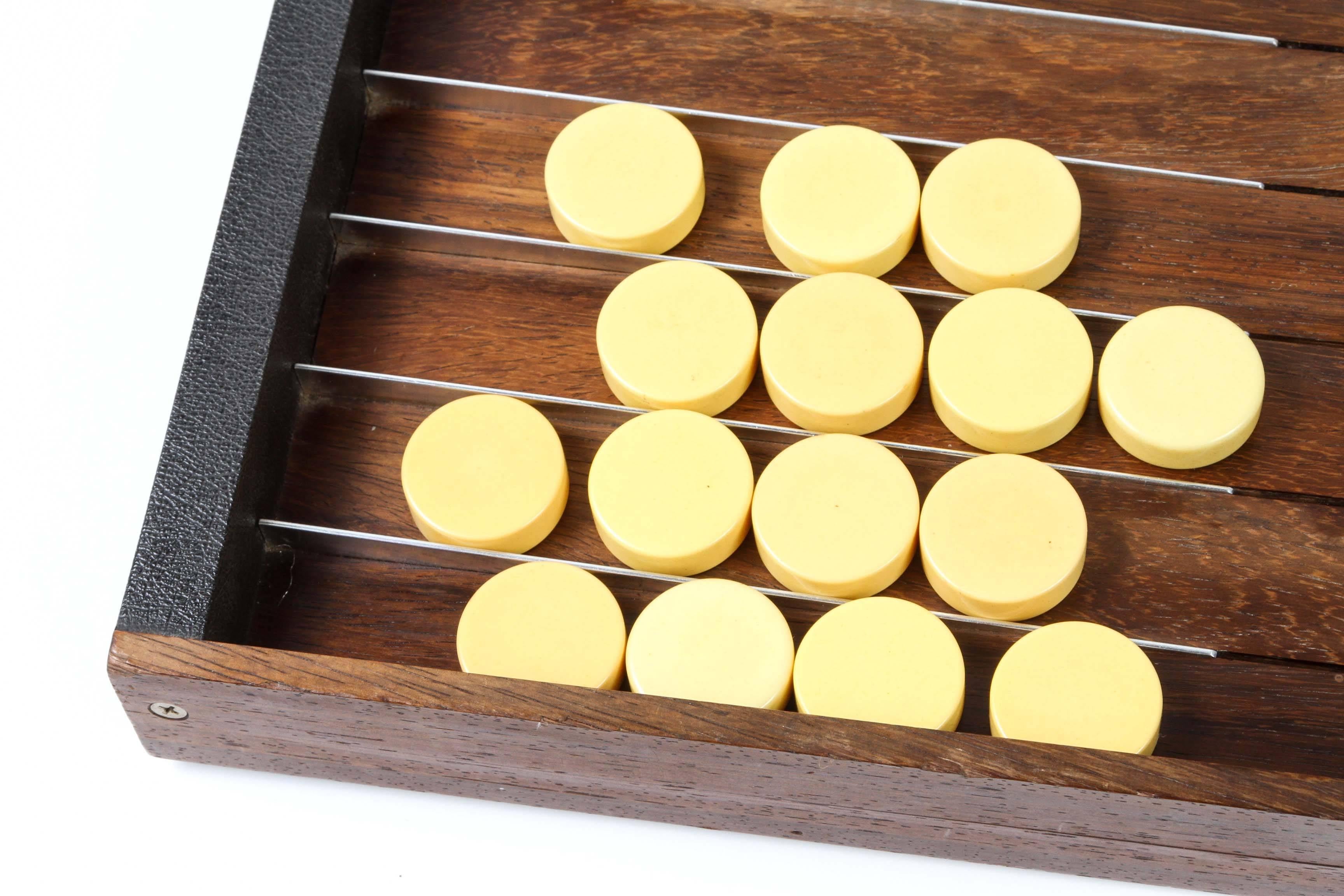 Unique handcrafted modern wooden backgammon set board.
Backgammon board in black embossed lizard faux and wood and metal.
15 red bakelite checkers, 15 ivory bakelite checkers and a set of two red and two white dice.
 