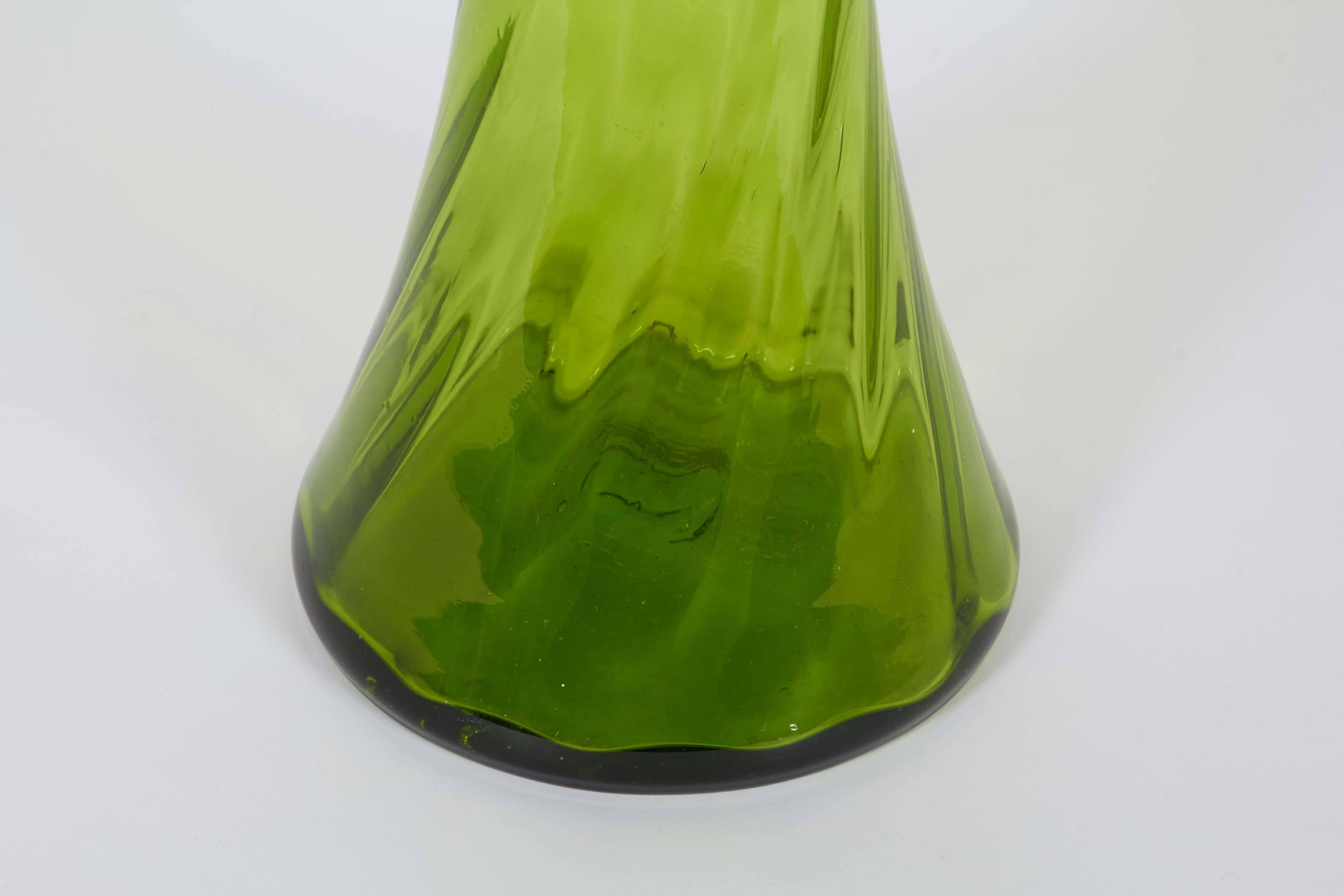 A circa 1960s blown glass floor vase in bright green by Blenko Glass of Milton, West Virginia, of waisted form with rippled detail. Very good vintage condition, any presence of wear consistent with age and use.

10989