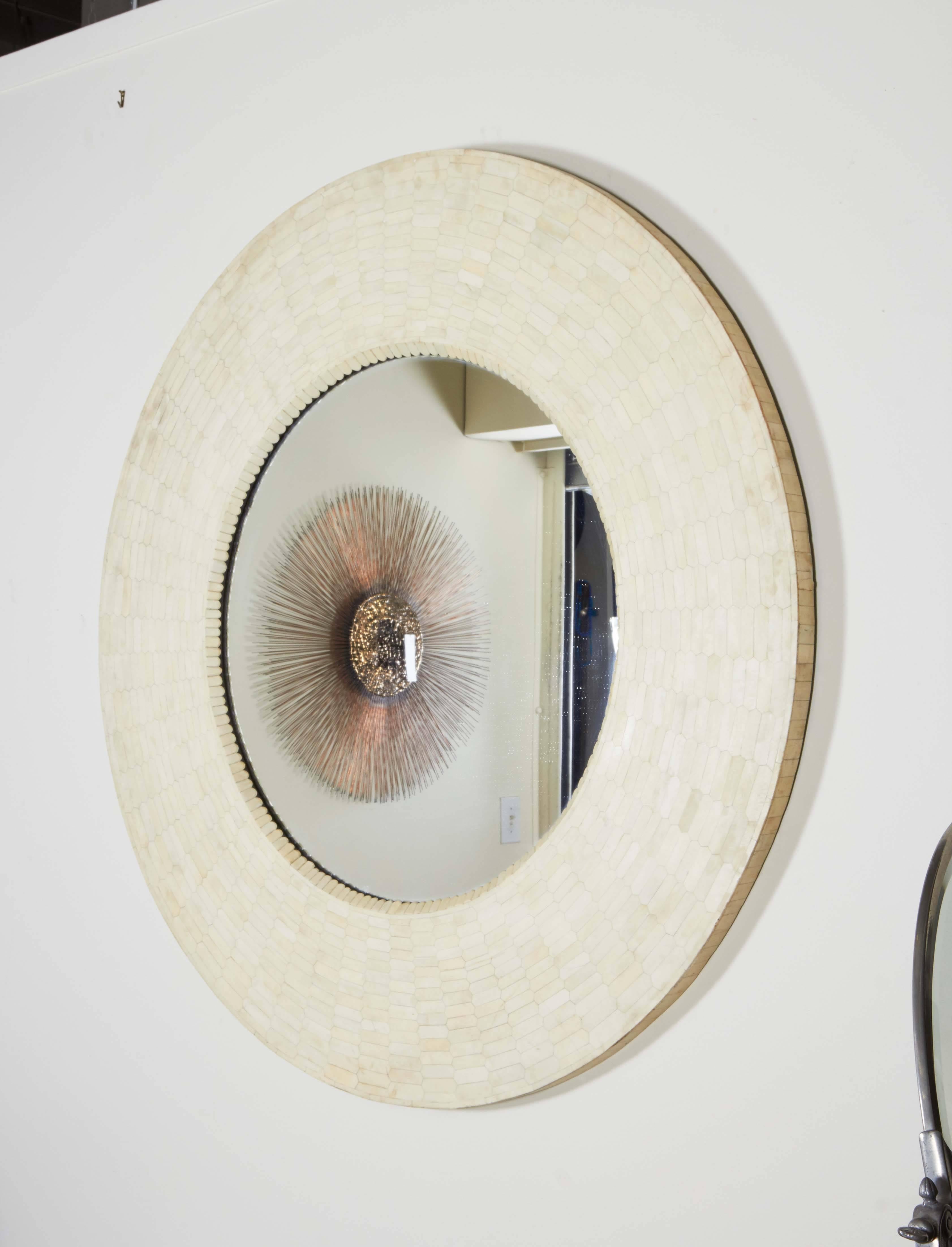 A modern style round wall mirror, with frame in tessellated bone veneer. Very good condition, wear to veneer consistent with age and use.