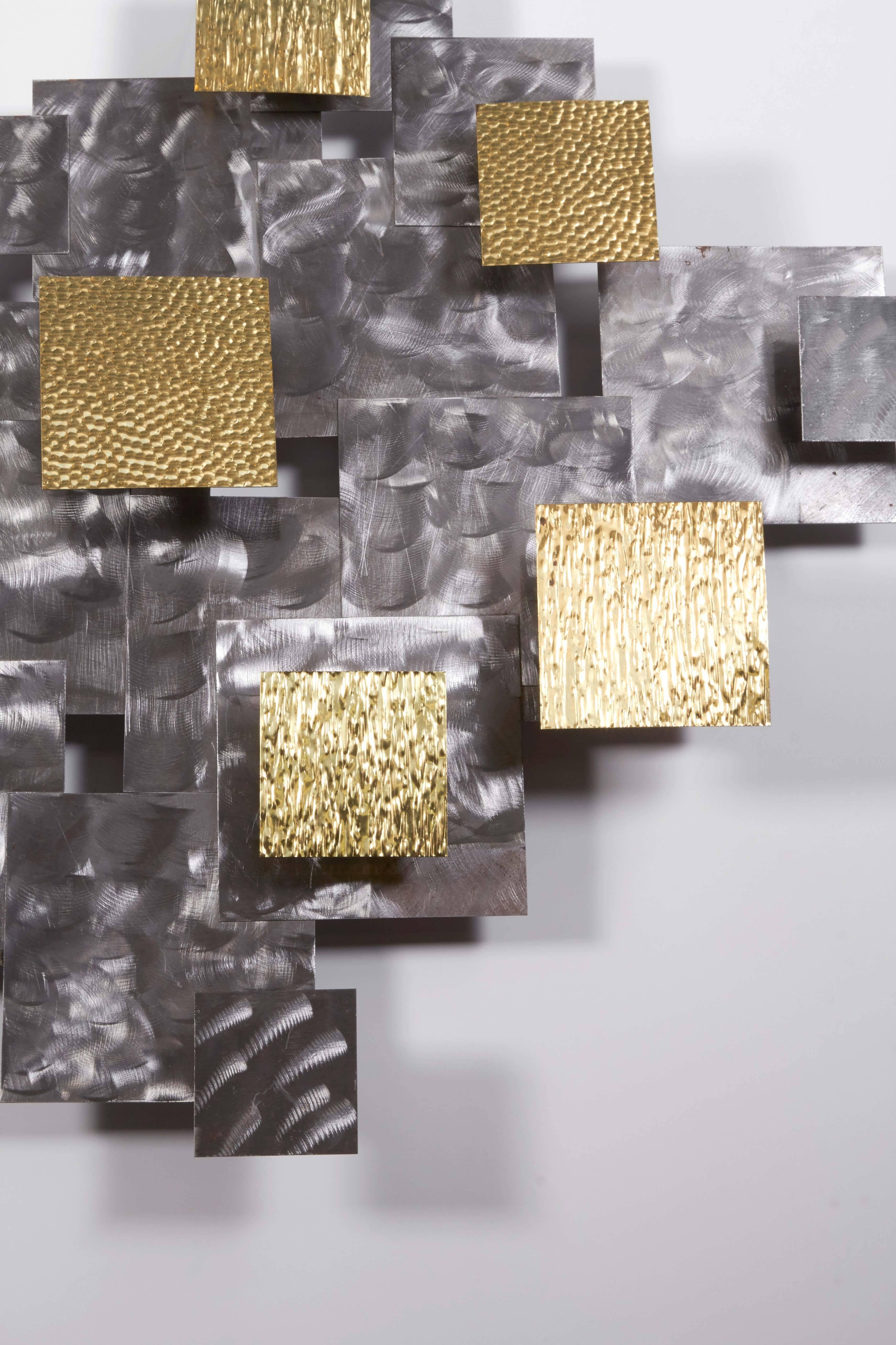 A Brutalist style Mid-Century era abstract wall sculpture, designed in the manner of Curtis Jere, comprising geometric sheets of mixed metals in brass and steel, featuring varying textures. Very good vintage condition, consistent with age and