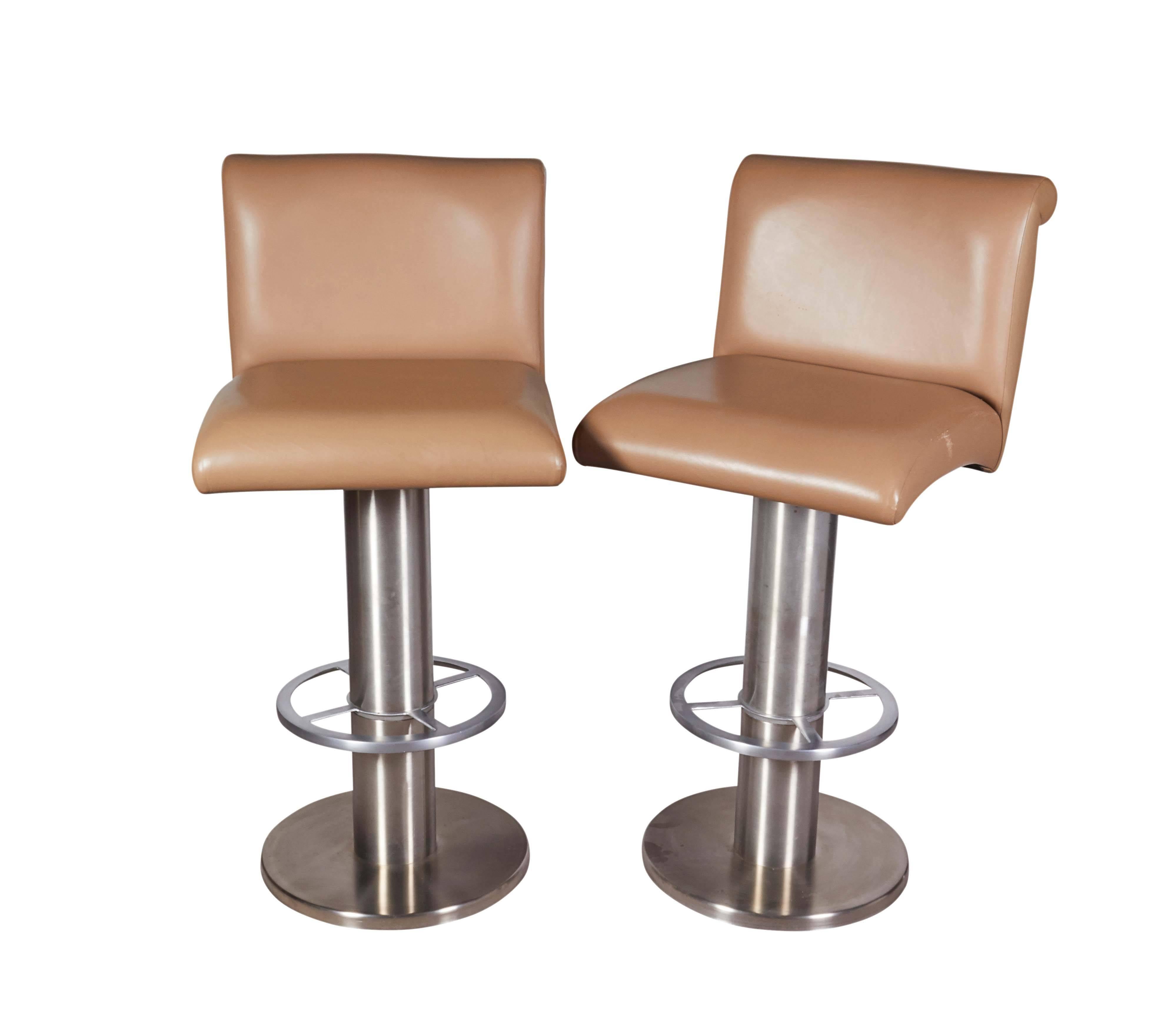 A set of five barstools, manufactured circa 1980s by Design For Leisure, backs and seats upholstered in beige leather, raised on bases in stainless steel. Includes original manufacturer's label. Very good original condition, age appropriate wear to