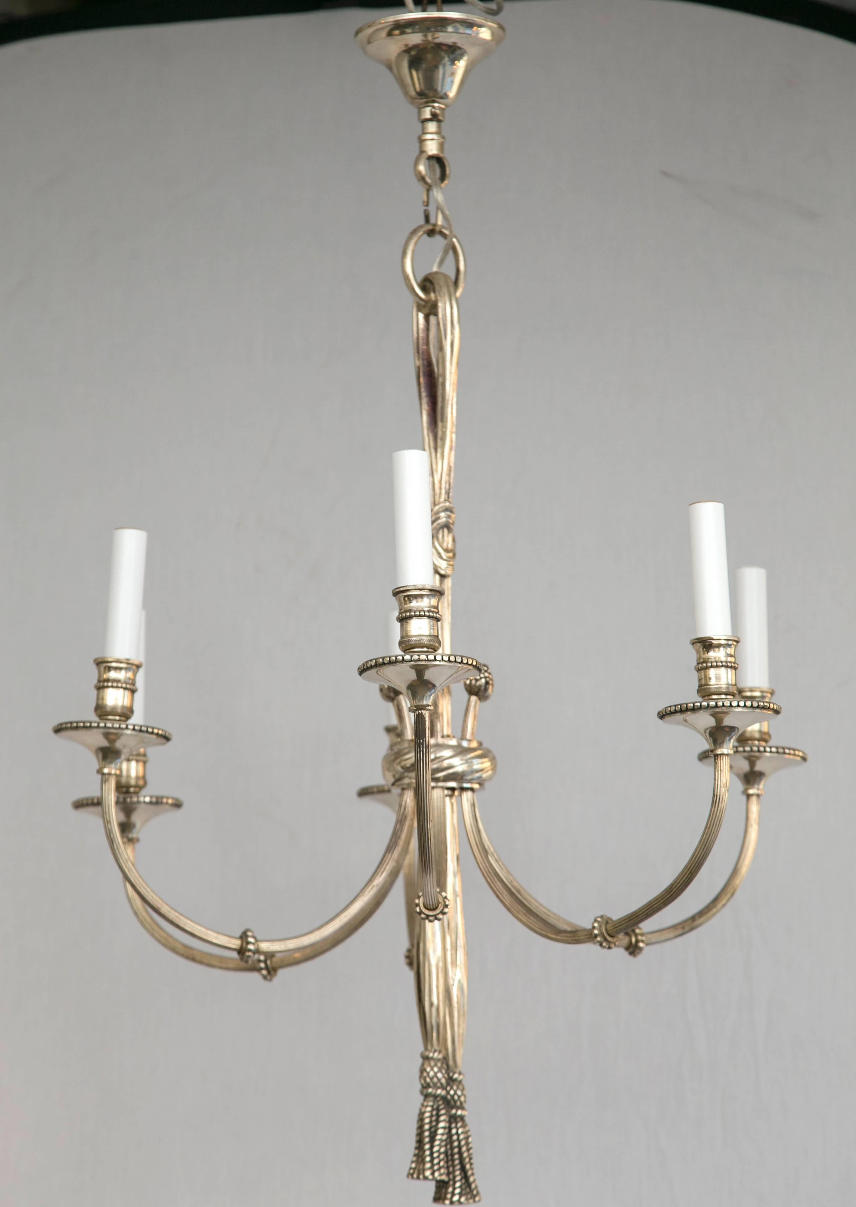 Bronze six-arm chandelier with tassel detail.