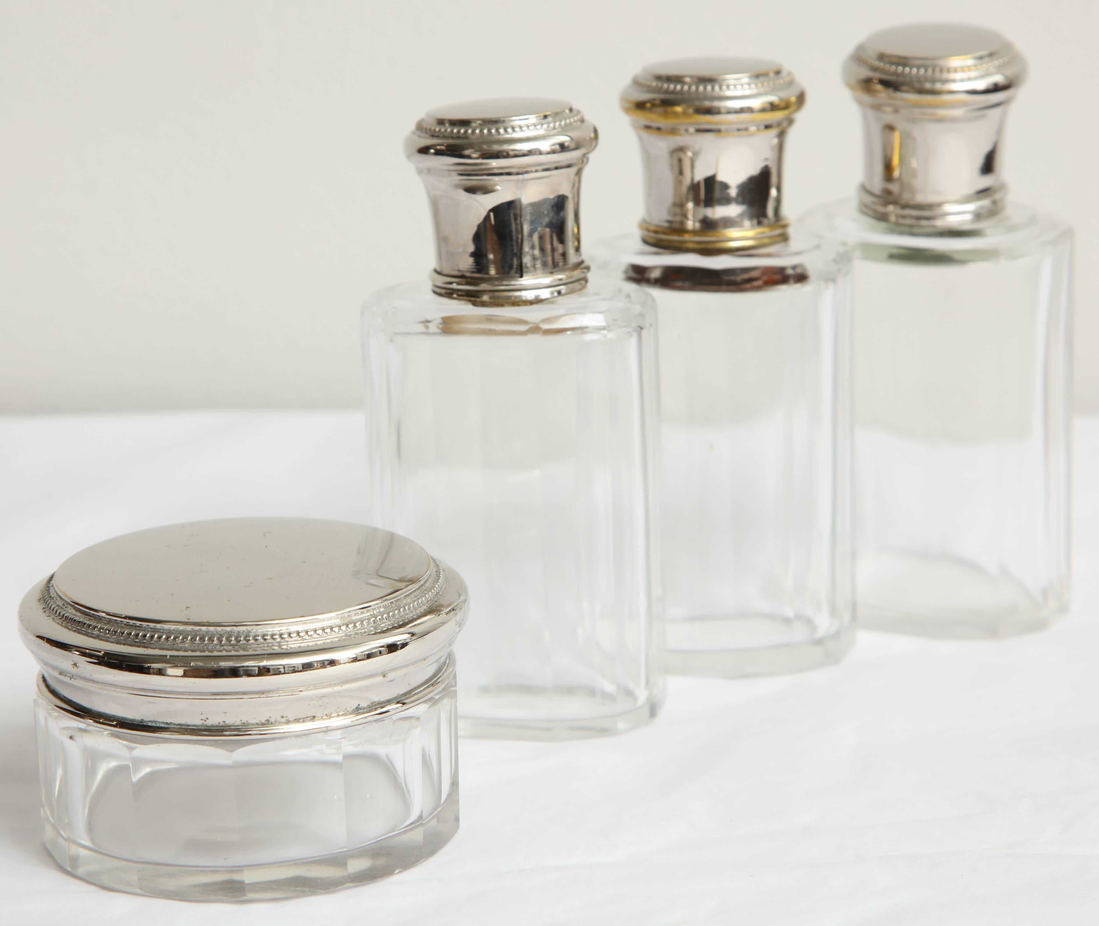 Set of four sterling silver and crystal toiletry bottles with covered round jar
Jar dimensions: 1.75
