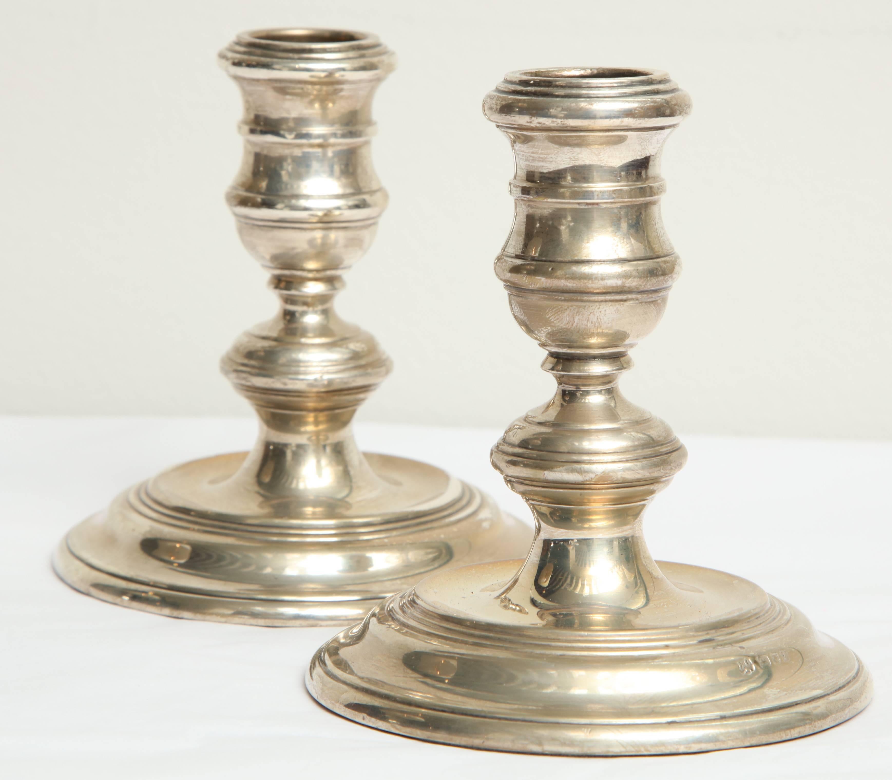 20th century pair of sterling silver candleholders, stepped circular base.