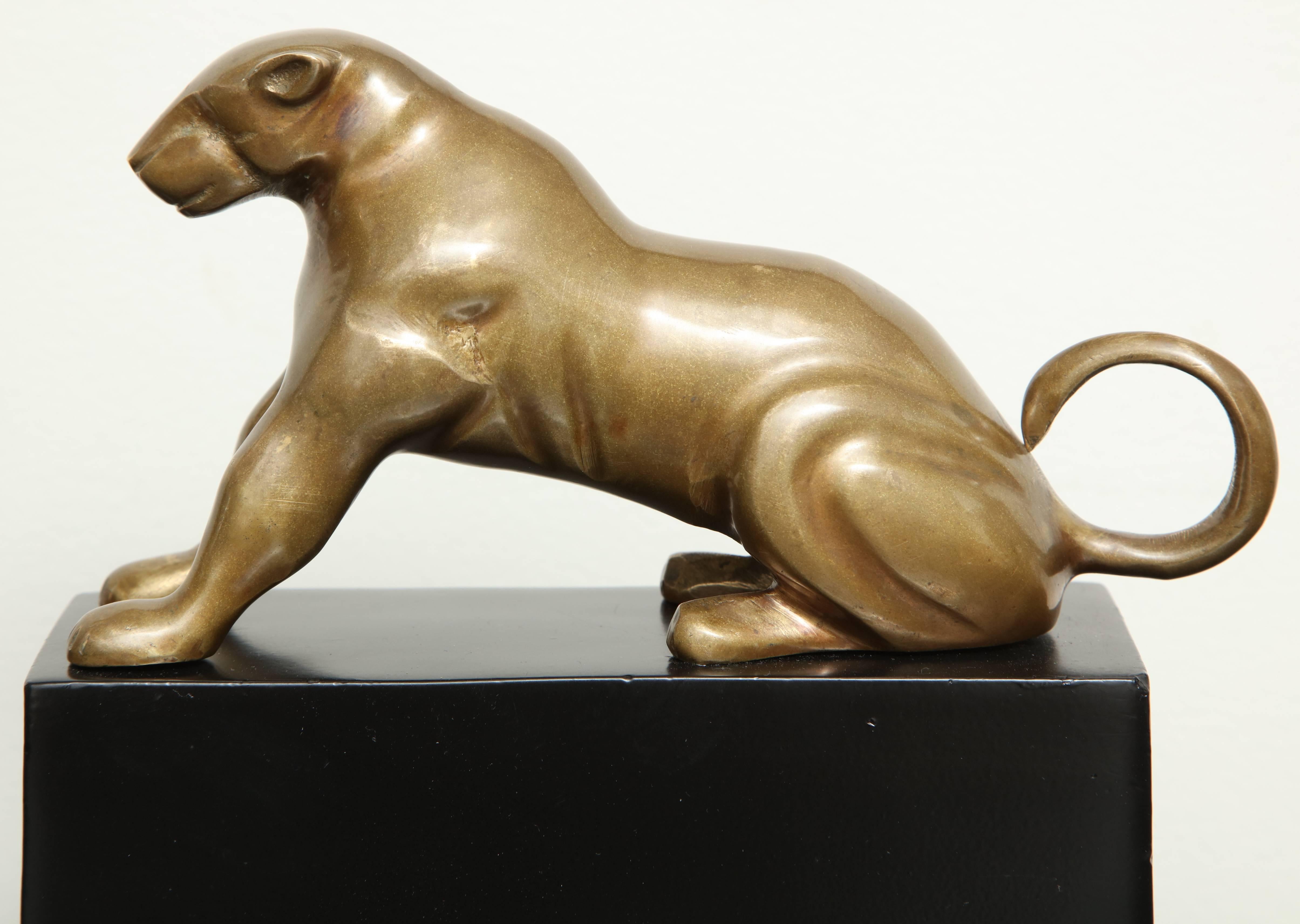 Pair of Mid-Century polished brass panthers, patinated aluminum bases.