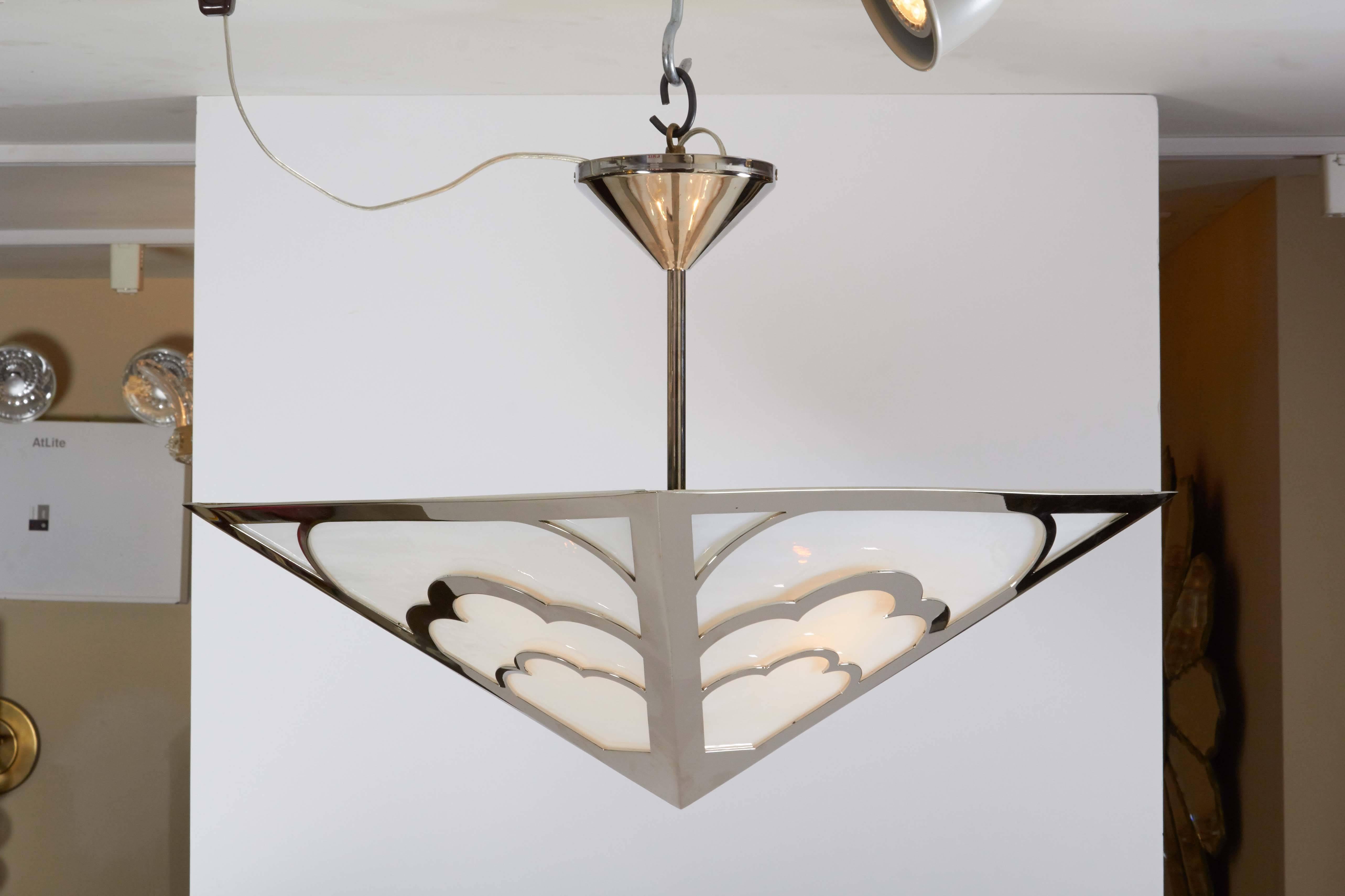 A square inverted pyramid shaped Art Deco style ceiling light, the frame with scalloped arches securing hand-blown swirled cathedral glass, the frame and funnel shaped canopy with polished nickel frame, stem and canopy, four candelabrum socket, 400