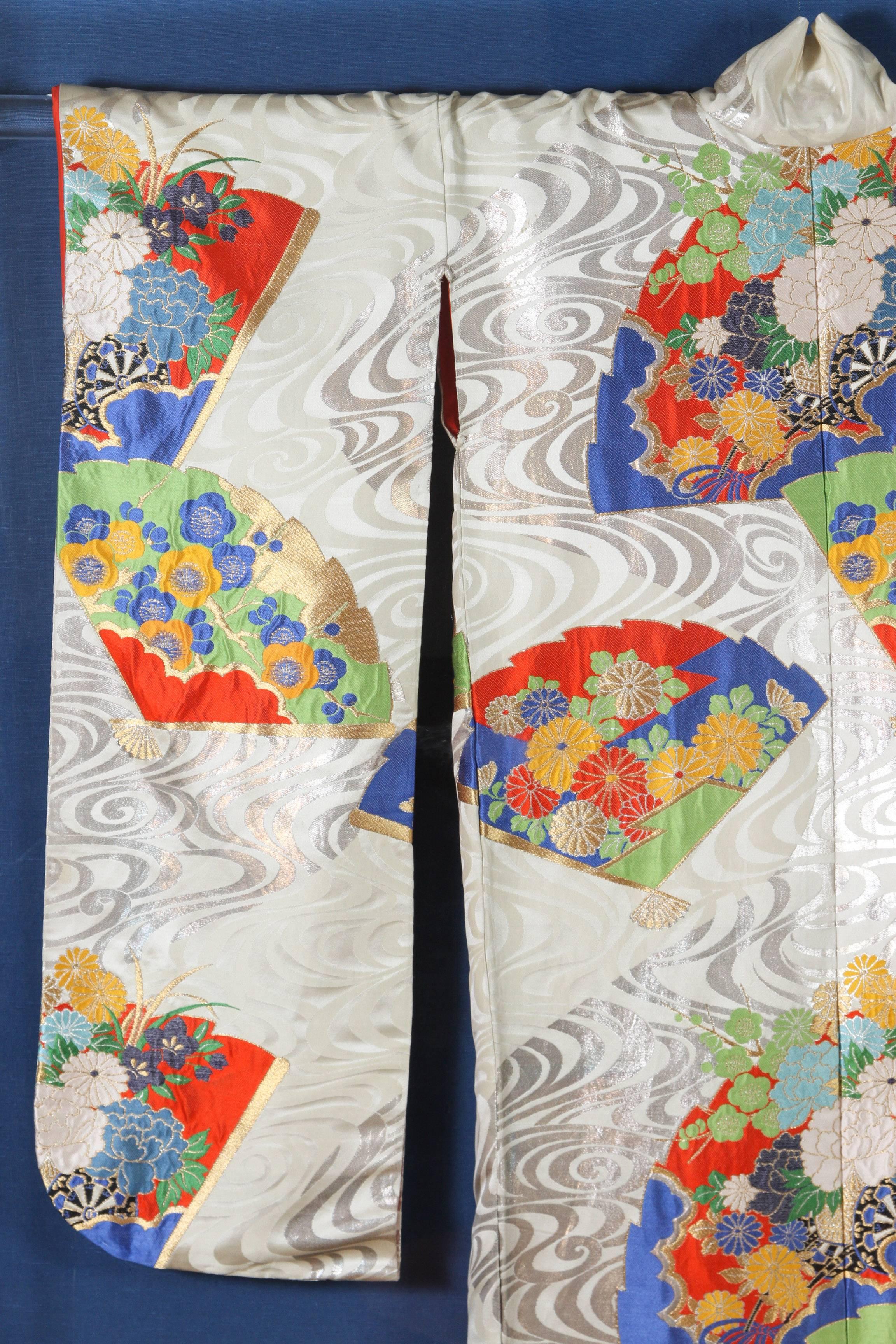 Japanese Ceremonial Kimono Framed in a Lucite box.
A vintage Japanese ceremonial kimono, circa 1940-1950, beautifully framed and displayed in a Lucite shadow box on blue background. 
An handcrafted unusual white, red and blue ceremonial piece in