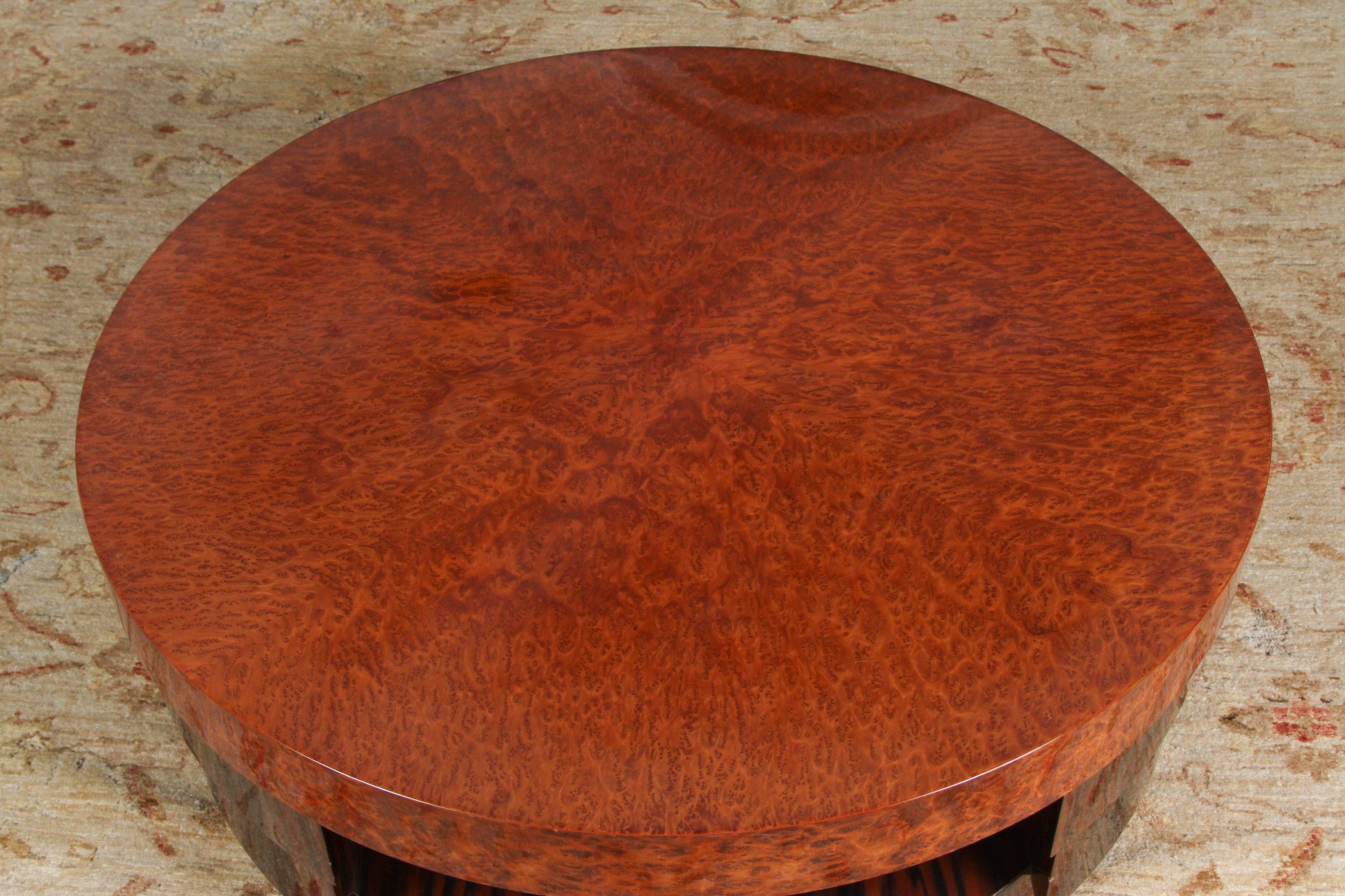 French Modernist Art Deco two-tiered round coffee table in beautiful lacquered two tone walnut burl and exotic wood Macassar like veneered finish.
High gloss lacquer finish which brings out the beautiful detail of the veneer.
A fine example of the