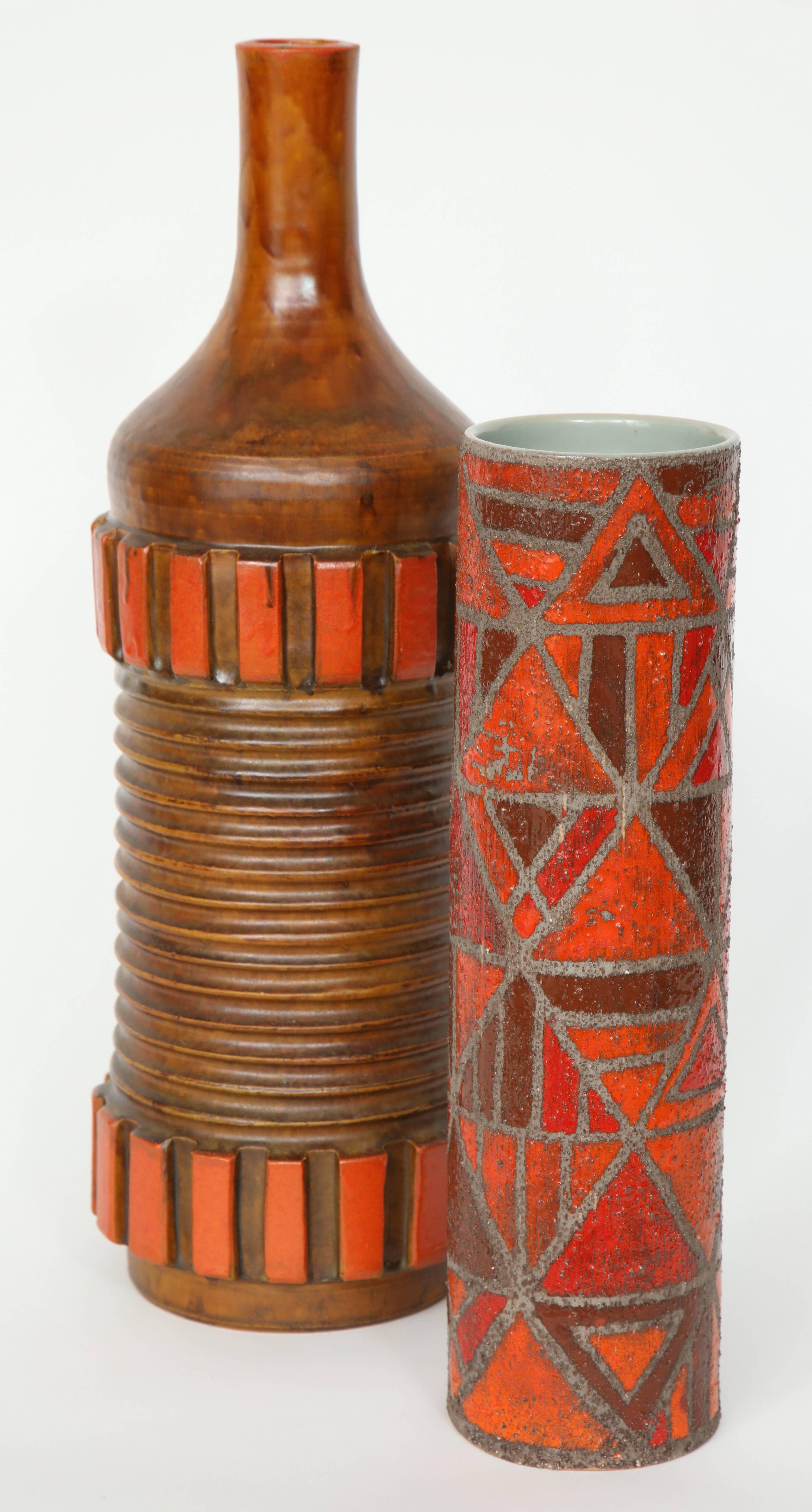 Single Italian ceramic vase in tones of brown and burnt orange, the smaller one featuring a geometric pattern and a sand glaze technique.

Measures: Geometric cylinder shaped measures 13