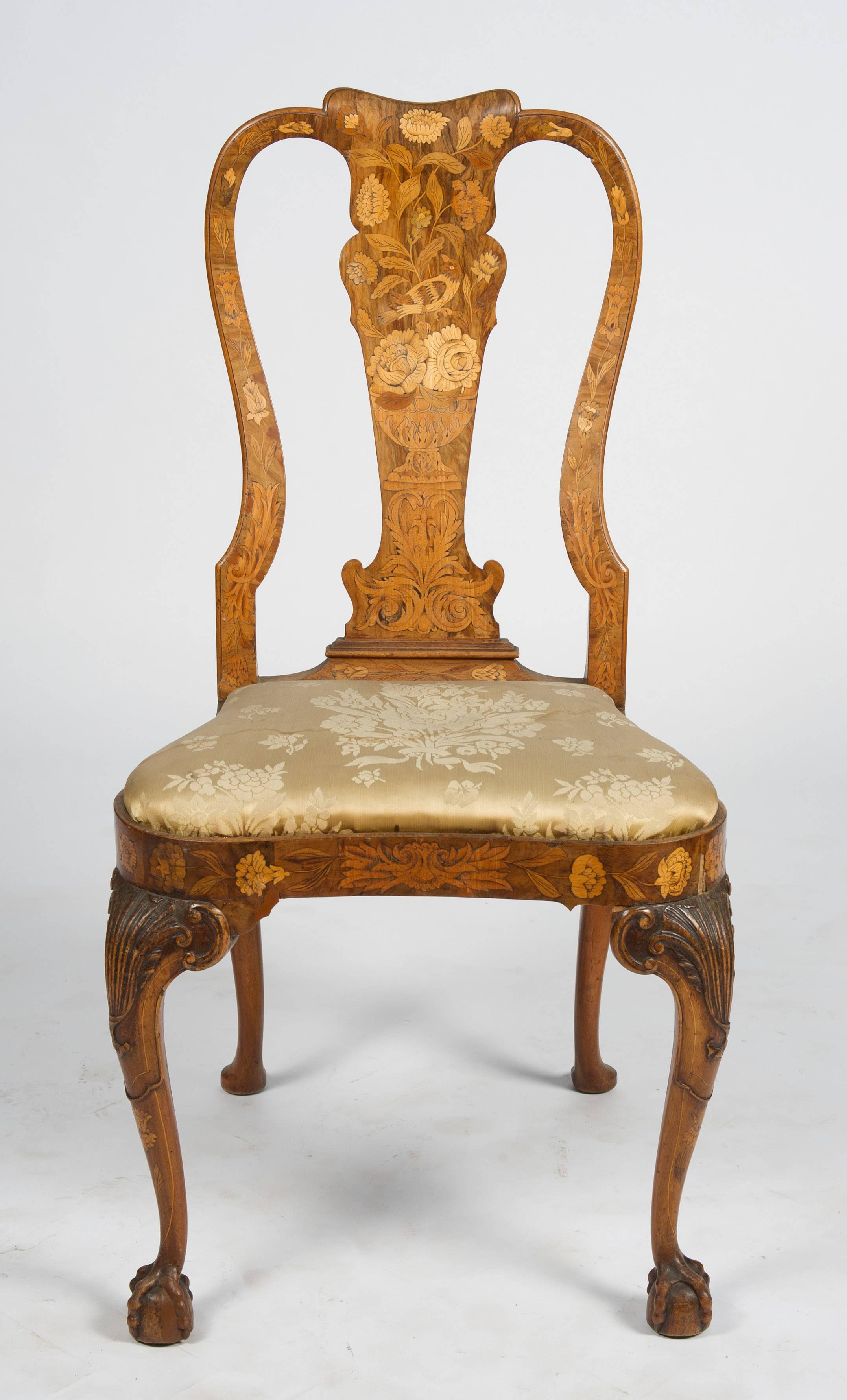 A fine quality set of four, 18th century Dutch marquetry side chairs. Each with wonderful vase shaped splats with flowers, leaves and birds inlaid, also to the apron. Drop in seats and raised on finely carved cabriole legs terminating in pad feet.